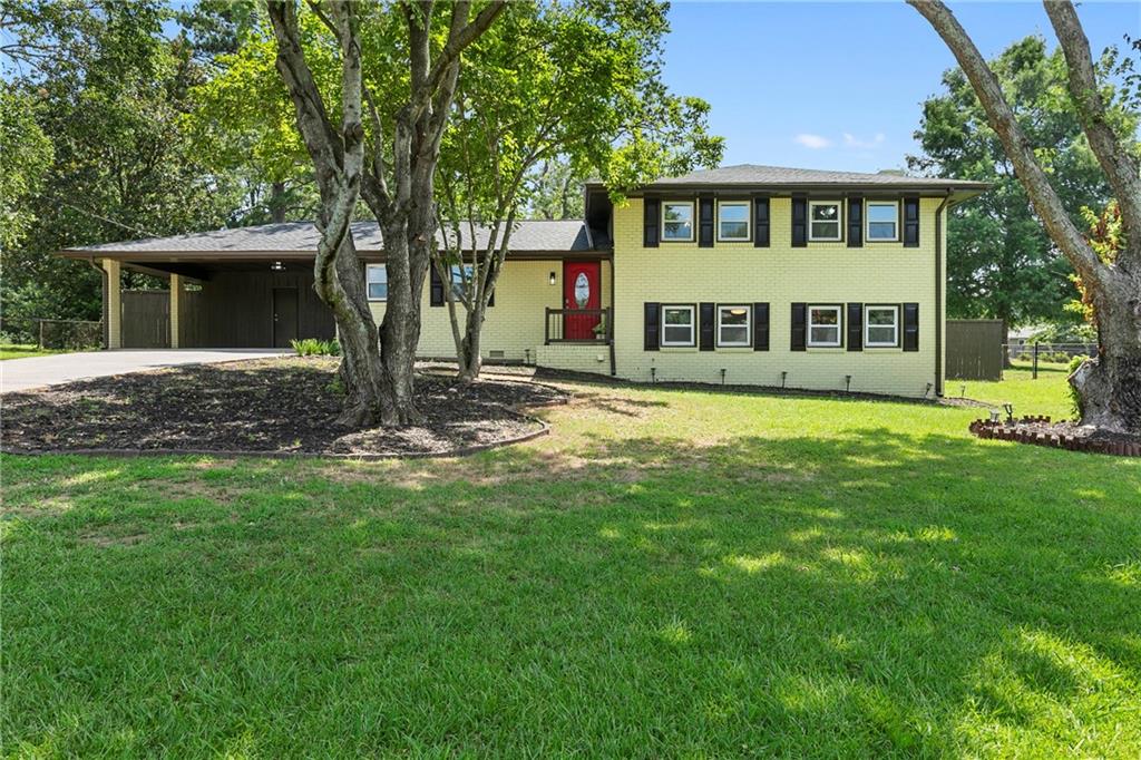 LOCATION LOCATION LOCATION! Welcome to 399 W. Sandtown Rd. this fully renovated split level 4 bedroom 3 bath home offers modern elegance with a classic layout- just minutes from Marietta Square. As you enter you will notice the beautiful refinished hardwood floors that lead you to the open concept kitchen and family room. The kitchen makeover features sleek cabinetry, all new stainless steel kitchen appliances, quartz countertops, updated kitchen tile and a breakfast island perfect for entertaining. Transitioning upstairs you will find 3 spacious bedrooms including the primary bed and full bath complete with a double vanity and beautiful rainfall shower system. The shared hall bath features designer tile and a rainfall shower adding a touch of luxury with spa quality features.
The terrace-level offers undeniable versatility. The lower level provides a bonus bedroom and full bath perfect for office space, in-law suite or even a teen den. Complete with a cozy fireplace this space has endless possibilities. The attached 2 car covered carport has a workshop/storage area. The leveled back yard has a 24x28 ft detached two car garage, that has the potential to serve as an ADU, workshop space etc. 399 W. Sandtown Rd. is move-in ready, fully renovated from top to bottom, with a new roof, new plumbing, electrical and HVAC systems and no HOA, all you have to do is unpack! Conveniently located in the sought after West Marietta community, Hillgrove school district and central to: grocery stores, shopping, healthcare, entertainment, restaurants and so much more, don't miss the opportunity to call this beauty home!