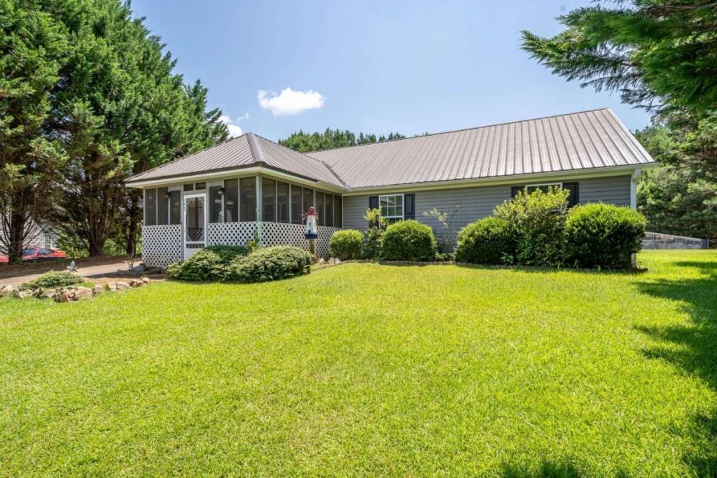 Peaceful One-Level Living on Over 1 Acre-Welcome to Juniper Drive-Located in the Wyngate subdivision in Ellijay, this charming 3-bedroom, 2-bath ranch home sits on over an acre in a quiet cul-de-sac with friendly neighbors and a serene mountain life setting. It's an ideal retreat for retirees seeking low-maintenance living or a great starter home for a small family-Enjoy easy, one-level living on a full slab foundation-no stairs to navigate! This home features updated appliances, low-maintenance vinyl siding, a garage, and screened porches for relaxing outdoors. The fenced backyard is perfect for pets, gardening, or simply soaking in the peaceful surroundings. All paved roads at a prime location just minutes to downtown Ellijay, Carters Lake, award-winning vineyards, orchards, shopping, dining, and scenic hiking and biking trails. Bonus for buyers 65 and older: Full-time Gilmer County residents are exempt from school taxes, making this an especially smart and affordable choice for retirement living. Don't miss this rare combination of comfort, convenience, and community-move-in ready and waiting for you!