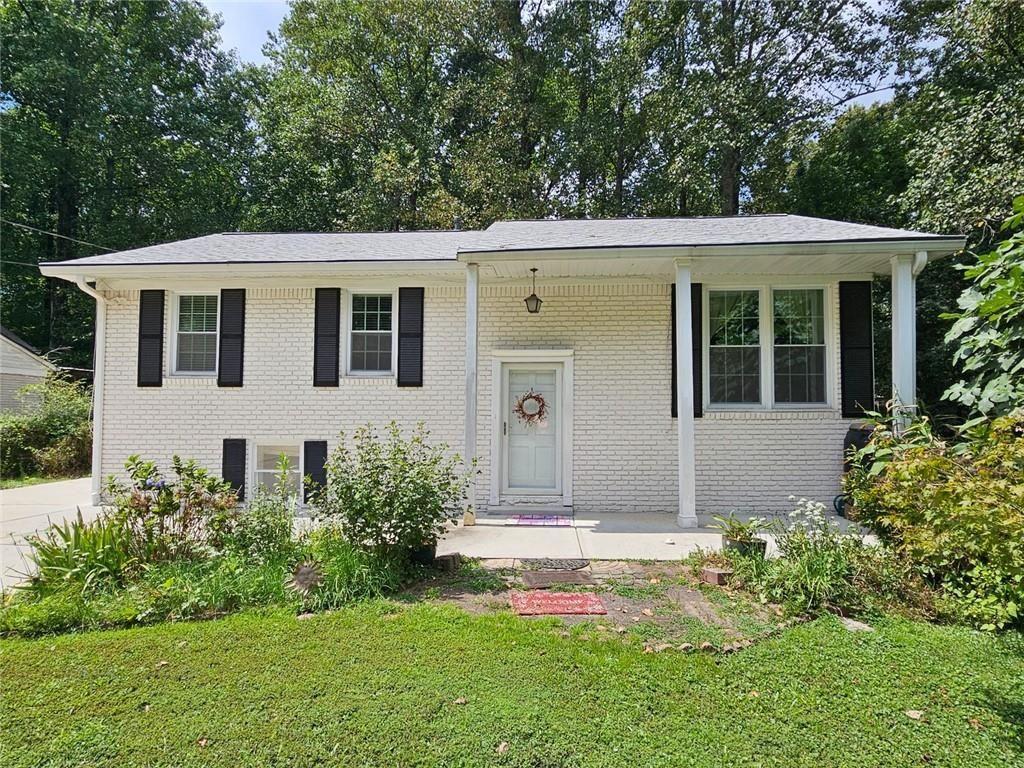 Priced to sell! Move right in and make it your own! This home presents an opportunity to embrace comfortable living in a highly desirable location. The open living area with its original hardwoods is anchored by the updated kitchen featuring a large island with lower cabinet storage and stone countertops. This kitchen is designed to be both functional and aesthetically pleasing while preparing meals and entertaining guests in this stylish and well-appointed space. This property includes four bedrooms and three bathrooms, and can be used as 3 separate living spaces or multi-generational with a second kitchen on the lower level. Alternatively, the open floor plan encourages a sense of togetherness. Enjoy the outdoors from the versatile sunroom, where you can appreciate the tranquil woods view and landscaped yard. Make this your office, bedroom, entertainment space, or additional living area to experience the beauty of nature from the comfort of your own home. Built in 1964, with 2640 square feet of living area, this residence offers a blend of classic charm and modern convenience with abundant possibilities. Enjoy close proximity to everything Perimeter and Downtown Chamblee have to offer. No HOA, voluntary Neighborhood Association, optional swim/tennis club. Huntley Hills Elementary offers a very popular and highly rated Montessori program. Newer roof, HVAC, driveway, sewer line, LVP flooring on lower level