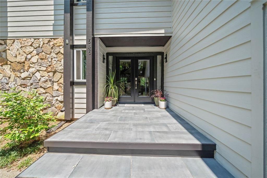 Mountain-Inspired Retreat in the Heart of Johns Creek. Tucked away on a quiet cul-de-sac in the highly sought-after Rivermont community, this bright and spacious 5-bedroom, 3.5-bath home offers the perfect balance of mountain retreat charm and suburban convenience. Step inside to a welcoming two-story foyer that opens to a grand family room featuring vaulted ceilings, a cozy fireplace, and a dramatic wall of windows that flood the space with natural light. The renovated owner’s suite on the main level boasts hardwood floors, a luxurious en-suite bath, and a private deck overlooking the peaceful, wooded backyard. The updated kitchen is a chef’s delight with granite countertops, newer cabinetry, stainless steel appliances, coffered ceilings, and a breakfast bar. The adjacent keeping room with fireplace flows seamlessly to the expansive deck, perfect for outdoor entertaining. Upstairs, you’ll find spacious secondary bedrooms and well-appointed baths, while the finished terrace level offers a billiard/game room, flex space ideal for an office, gym, or additional bedroom, plus unfinished storage/workshop space ready to meet your needs. Enjoy access to Rivermont’s private park on the Chattahoochee River, along with proximity to top-rated schools, local dining, shopping, and all the natural beauty of North Fulton County.