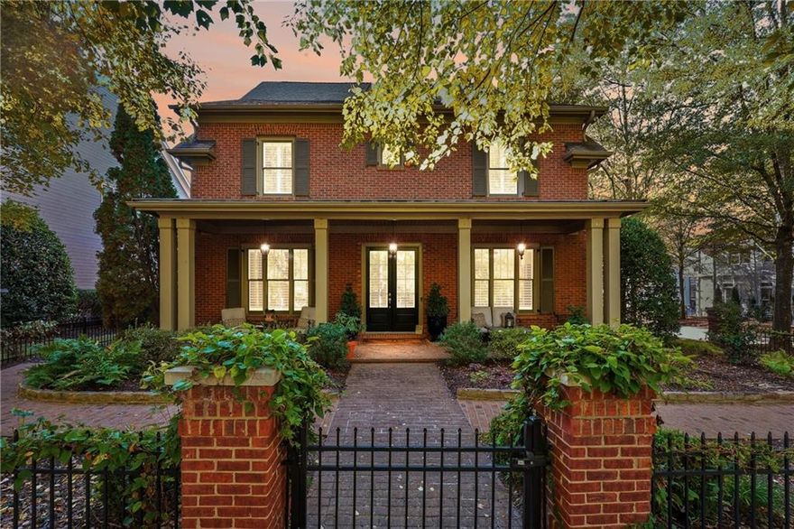 Welcome to this stunning former model home in highly sought-after Crabapple Crossing, just steps from the charming shops and dining of downtown Crabapple. This classic brick traditional shines from the moment you arrive with upgraded details including wide baseboards, custom millwork, and fresh hardwood flooring throughout the main level.

The updated kitchen features quartz countertops, stainless steel appliances, and a custom center island that seamlessly opens to the fireside family room with coffered ceilings and custom built-ins — perfect for everyday living and entertaining alike. A redesigned main-level powder room adds a fresh, modern touch. Plantation shutters throughout provide timeless style and enhanced privacy in every room.

Retreat to a backyard designed for year-round enjoyment with an Italian-inspired atmosphere: an outdoor wood-burning fireplace, water features, brick and stone garden architecture, a retractable lanai cover, and evening uplighting that transforms the space into a beautiful oasis.

Upstairs, you'll find fresh carpet and paint, along with spacious bedrooms and a fully renovated primary bathroom offering a spa-like experience.

Additional upgrades include an epoxy-sealed garage floor along with added storage cabinetry — a clean and organized space for everything.

With HOA-maintained lawn care, you’ll have more time to enjoy this incredible lifestyle. All of this just moments from award-winning schools, parks, and the vibrant offerings of downtown Crabapple.