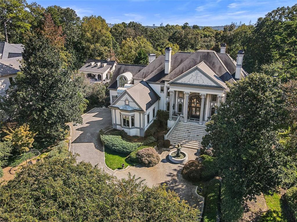 Private 2 acre +/- gated estate, long winding driveway with breathtaking approach. Grand two story foyer with amazing staircase, Gourmet kitchen views to vaulted keeping room. Custom hardwood flooring throughout. Two story fireside gentleman's study with spiral staircase. Private owners suite with spa like bath, separate His & Hers closets. Terrace level features; custom bar & wine cellar, Egyptian themed theater, exercise room, with steam & sauna, elevator. Covered Loggia with outdoor fireplace, heated saltwater pool, spa with waterfall. Security & camera system. Self contained guest house with kitchen, bedroom with full bath & game room. Lighted tennis/sport court.