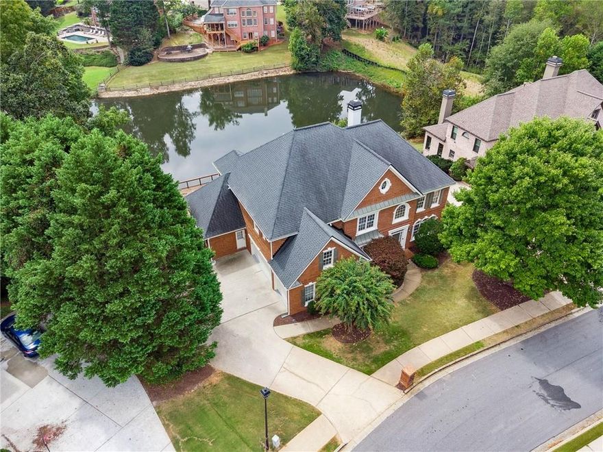 Welcome to your newly renovated lakefront home in the highly sought-after swim/tennis community of Glenn Abbey!

This stunning four-sided brick home impresses from the start with its grand two-story foyer and soaring 18-foot windows in the great room, showcasing breathtaking views of the lake. The chef’s kitchen has been beautifully remodeled, as have all bathrooms, creating a modern, move-in ready feel. With two fireplaces on the main level, the home is perfect for both everyday living and entertaining. Step onto the expanded oversized deck and enjoy peaceful moments overlooking the water.

Freshly painted throughout with refinished hardwood floors, this home offers 6 bedrooms and 5 bathrooms, providing space for the entire family. A bedroom with full bath on the main level is ideal for guests or multigenerational living. Upstairs, the oversized primary suite features its own fireplace, a luxurious spa-like bath, and serene lake views—your private retreat. Three additional bedrooms complete the upper level.

The fully finished terrace level adds even more living space with a walkout to the backyard, abundant storage, and potential for future customization.

This rare lakefront opportunity blends elegance, functionality, and resort-style living—all in a prime Alpharetta location. Don’t miss the chance to make this your forever home!