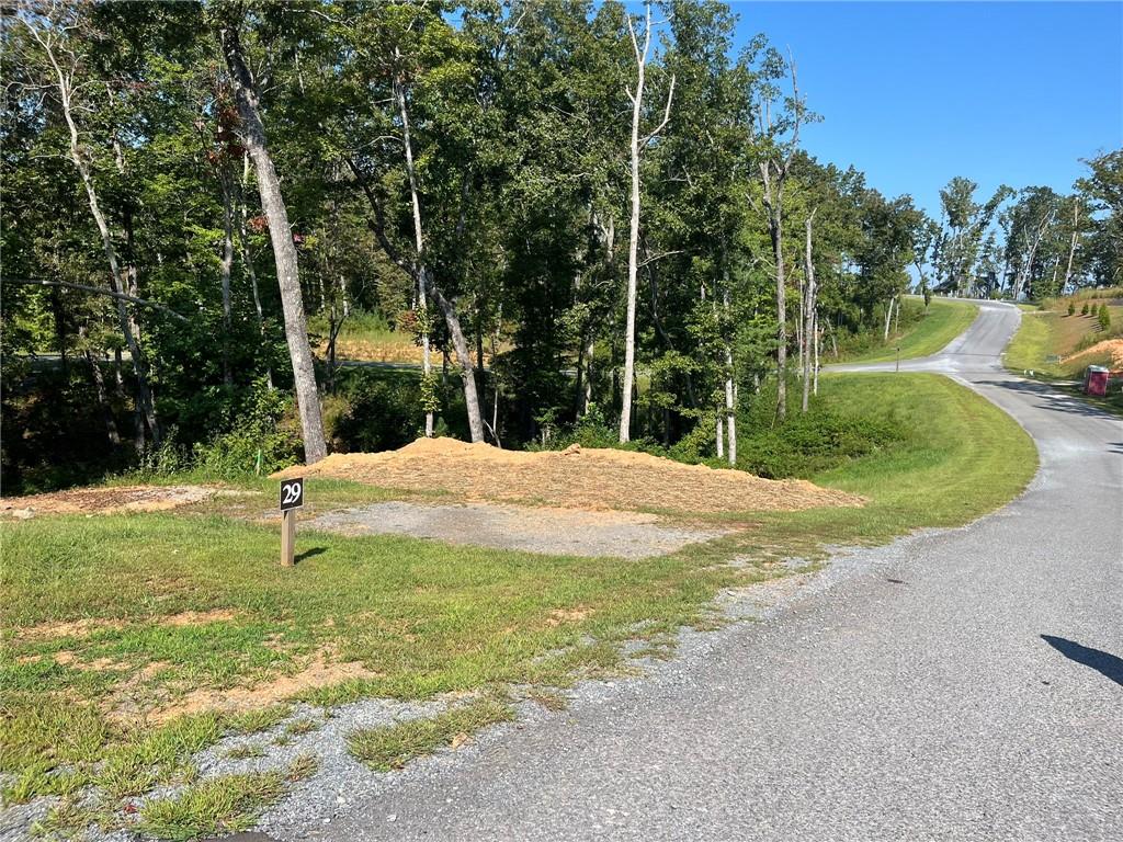 Welcome to your slice of tranquility in the North Georgia mountains. Nestled in the peaceful Jakes Landing Overlook subdivision, 148 Jakes Landing Way S offers just over one acre of wooded land, providing the perfect backdrop for your dream home or private mountain retreat. The residential zoning allows flexibility for a variety of home designs, and with modest property taxes, it’s an affordable opportunity to own land in this desirable area. Located only a short drive from downtown Ellijay, you’ll enjoy the charm of local shops, restaurants, and community events, as well as easy access to hiking, fishing, and the outdoor adventures that make this region so special. Whether you’re looking to build now or invest for the future, this lot offers the perfect combination of natural beauty, convenience, and potential.