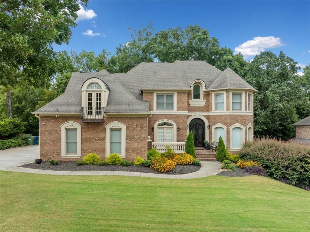 Welcome to this exquisite executive residence located in the prestigious Guilford Forest Subdivision—a well-established, amenity-rich community offering a two-level clubhouse, swim and tennis facilities, and a strong sense of community. This move-in ready home has been thoughtfully updated and beautifully maintained, featuring rich hardwood flooring throughout the main living areas and brand new LVP flooring in the fully finished terrace level. Step into the grand two-story foyer and enjoy a seamless flow into the gourmet kitchen overlooking a spacious great room with one of three elegant fireplaces. A formal dining room sets the stage for unforgettable gatherings, while the main level includes a guest suite with a full bath. Upstairs, the luxurious owner’s suite boasts a private sitting room, Juliet balcony, and a spa-inspired bath with a jetted tub. Secondary bedrooms are generously sized, offering flexibility for family, guests, or home office use. The fully finished terrace level is an entertainer’s dream—complete with a freshly painted home theater, full bar, additional bedroom and bath, and private entry—perfect for a teen or in-law suite. Brand new stained back doors lead to a newly built deck ideal for entertaining. Additional features include a full ADT security system with cameras and NEST thermostats for smart, energy-efficient living. Conveniently located near Hartsfield-Jackson Atlanta International Airport, Camp Creek Marketplace, Southwest Arts Center, Wolf Creek Amphitheater, Mable House Barnes Amphitheatre, and just 15 minutes from Six Flags, this home seamlessly blends timeless charm with modern luxury in one of Southwest Atlanta’s most desirable communities. Schedule your showing today and explore what homebuyer programs you may qualify for with my preferred lender—this incredible home will not last!