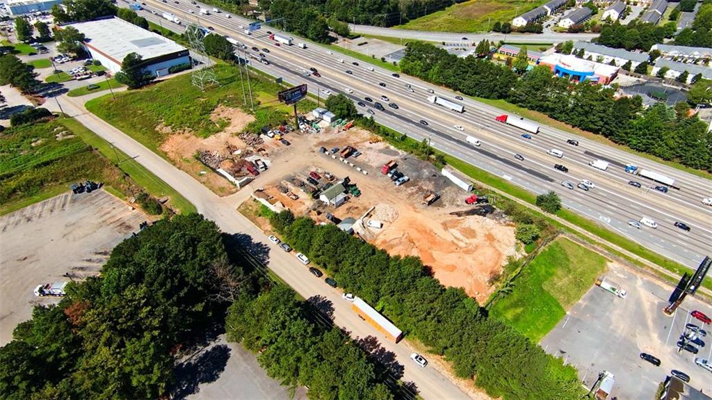 Prime Commercial LOT (including 2 parcels) on Interstate 85N frontage Road. Lot is located between Indian Trail & Jimmy Carter. Over 280,000 traffic counts a day. Prime location with high visibility from one of the populous county in GA. Currently zoned M1. Level lot with public utilities. Why pay for billboard when you can put a sign on your own building! Call for more information!