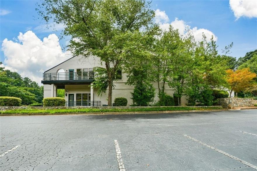 Fully renovated office condominium overlooking Mallard Cove pond. Bright and inviting space with plenty of natural light, windows, and a deck with water views. The suite features eight offices, including four with water/pond views, one very large in size suitable for a conference or a group room, a large reception area, break room/kitchenette, two bathrooms, and ample storage. An open foyer with architectural details provides a professional entry, while many offices include soundproofing along with updated carpet, tile, and hardwood flooring. 

Located right off of interstate 75, just one mile from the Braves Stadium and close to the new Porsche dealership and Wellstar building, this property offers excellent visibility in a rapidly growing business district with ample on-site parking. Well suited for therapists, attorneys, accountants, or medical professionals, as it combines quality finishes, practical layout, and a prime location.