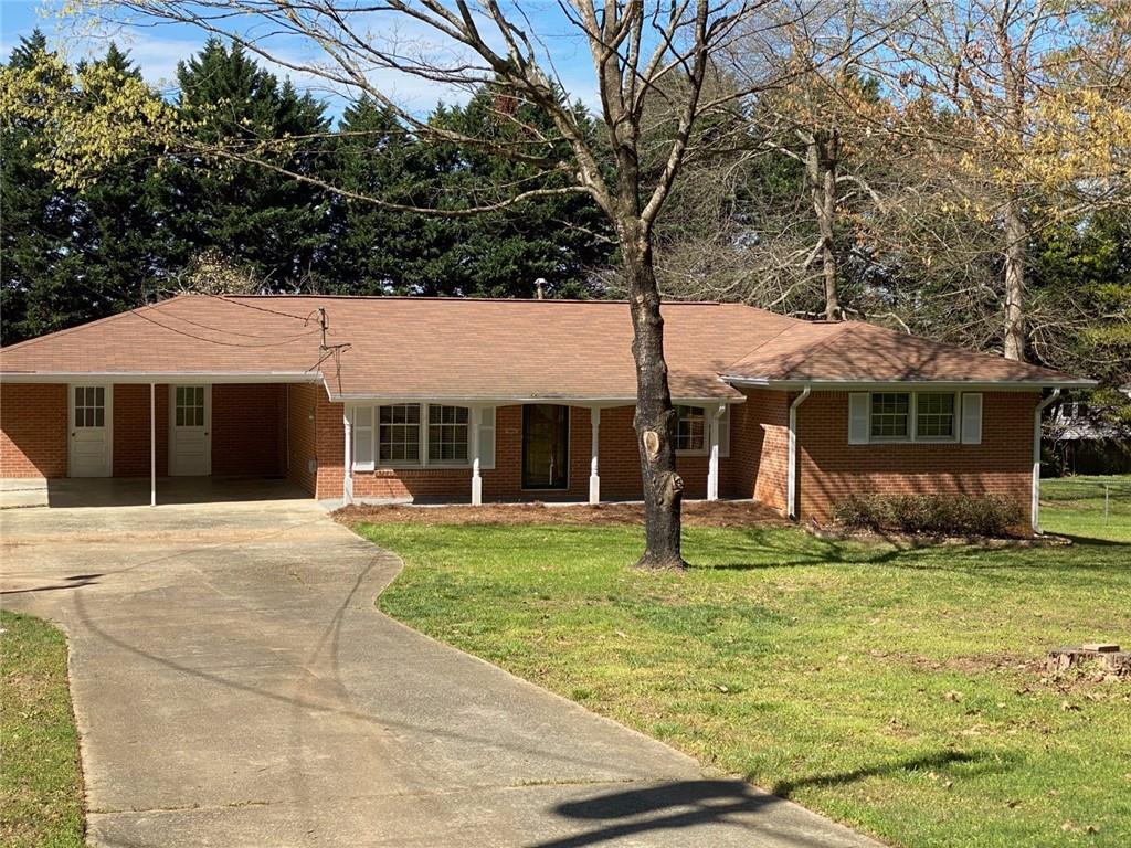 This spacious, 3 bedroom, 2.5 bathroom, brick ranch has been beautifully updated. The kitchen has large windows overlooking a large, private backyard, lots of cabinet space, stainless appliances and granite countertops. Separate laundry room with a door leading to a nice wood deck. Primary suite has its own bath featuring separate vanities, toilet, walk-in shower with glass enclosure and a closet. Secondary bedroom has its own half bath - perfect for guests. No pets allowed. Lawn care included. Septic system maintained. Quiet, secluded street just 1 mile from Peachtree Industrial Blvd and within walking distance from historic downtown Duluth. Must see!