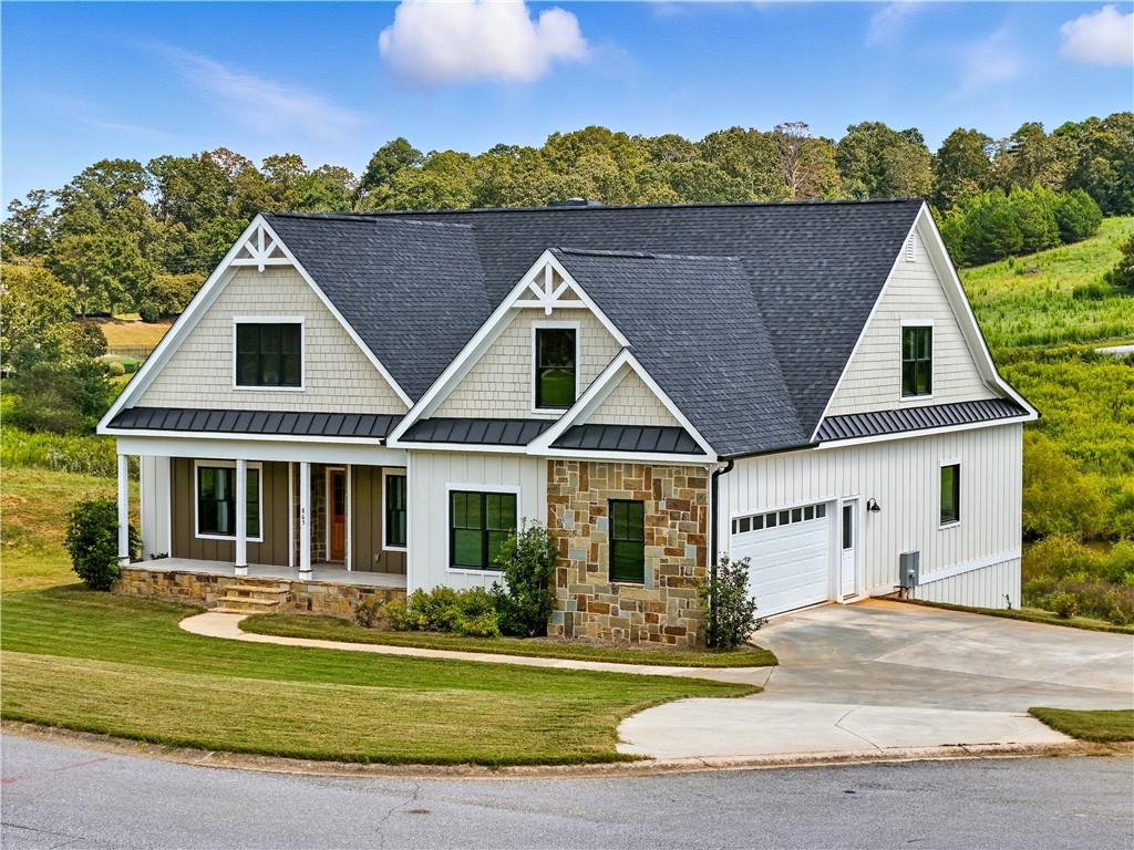 Welcome to this stunning 1.5 story ranch with a full basement, nestled in the foothills of the Blue Ridge Mountains. Perfectly positioned on one of the community's few remaining premium cul-de-sac lots with a tranquil pond view, this home offers a serene retreat with unmatched style and quality. The builder spared no expense, showcasing premium finishes throughout-from Blue Wood Pine and tongue & groove pine ceiling and wall accents, to soaring 12' Blue Wood coffered ceilings and natural stone masonry details inside and out. The gourmet kitchen is a true showstopper with leathered quartz countertops, Maytag stainless steel appliances, under-cabinet lighting, and abundant space for entertaining. Luxurious touches continue throughout the home, including a tankless water heater, Belgard paver terrace-level patio, and thoughtfully designed living spaces. Situated on city sewer and crafted with timeless detail, this 4-bedroom, 3-bath residence in Sweetgrass combines rustic elegance with modern comfort. Don't miss the opportunity to experience this exquisite home and its breathtaking setting!