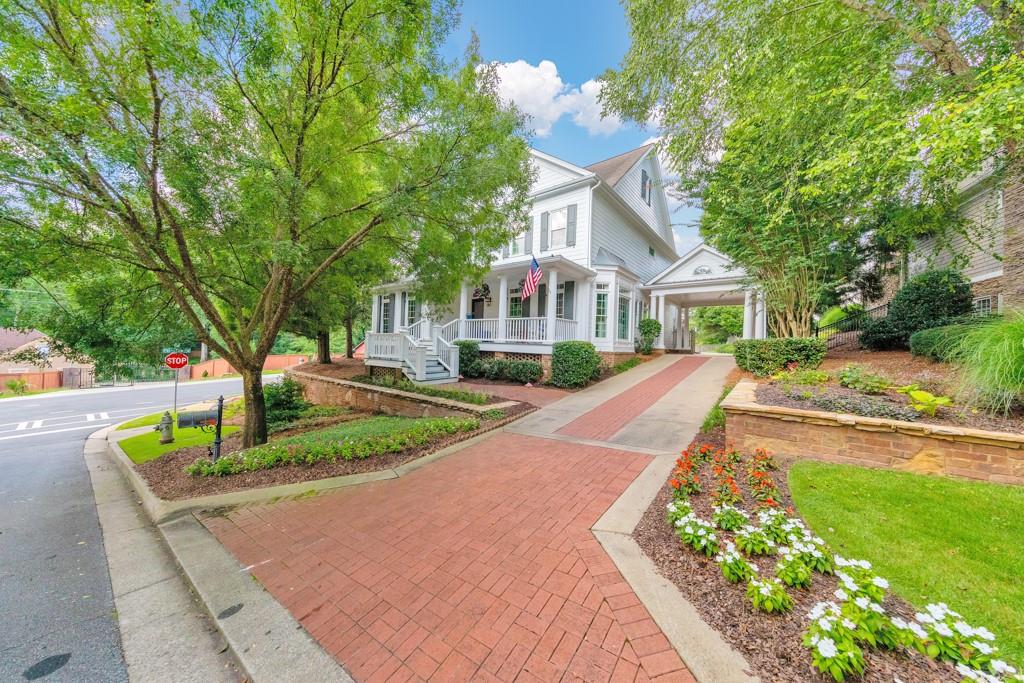 Welcome to this stunning 5 bedroom, 5.5 bathroom home in the Hazelhurst Ridge community in East Cobb! This beautifully maintained residence is filled with designer touches, featuring hardwood floors on the main and upper levels, crown molding, recessed lighting, and thoughtful upgrades throughout. A charming covered front porch leads you into a spacious foyer flanked by a formal dining room and an office with French doors. The fireside family room with built-in bookshelves flows effortlessly to the updated kitchen, complete with stone countertops, a center island with seating, and a sunny breakfast room. The main level also offers a convenient laundry room with a sink and a half bathroom. Upstairs, the oversized primary suite impresses with tray ceilings, a spa-like ensuite bathroom with double vanities, a soaking tub, a glass-enclosed shower, and a large walk-in closet with built-ins. Two generously sized secondary bedrooms each feature their own private ensuite bathrooms. The finished basement offers incredible additional living space with a large media room with a fireplace, a bonus room, a bedroom, and a full bathroom. A detached 3-car garage includes a private bedroom or flex space with its own full bathroom above — perfect for guests, an office, or studio. Enjoy multiple outdoor living areas including a covered side deck, a terrace-level patio, and a rear patio with an outdoor fireplace overlooking the massive fenced-in backyard. Ideally located just around the corner from Lassiter High School and minutes from shopping, dining, and major roadways — this home truly has it all!