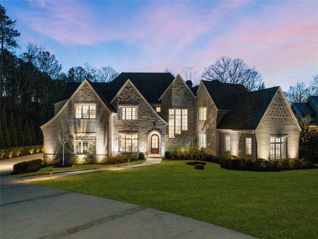 Situated on a picturesque 1.4+/- acre lot, this stunning custom home was built for entertaining on a grand scale with an effortless indoor/outdoor flow. The show-stopping kitchen features a center island with a stunning marble waterfall countertop for casual seating adjacent to the open dining area with custom steel doors leading out to the terrace. A large pantry serves as a prep area with additional appliances and extensive storage. The fireside family room invites relaxation with a custom home entertainment system. Owners' suite on the main level features an oversized bathroom with walk-in shower, luxurious soaking tub, dual floating vanities, and massive walk-in closet. Upstairs boasts 4 spacious bedrooms with private bathrooms and a bonus room. The finished terrace level is outfitted with an impressive home theater, wet bar, family room, exercise room and private guest suite. Additional enviable features include a 4-car garage, smart home technology, heated saltwater infinity pool with spa and guesthouse.