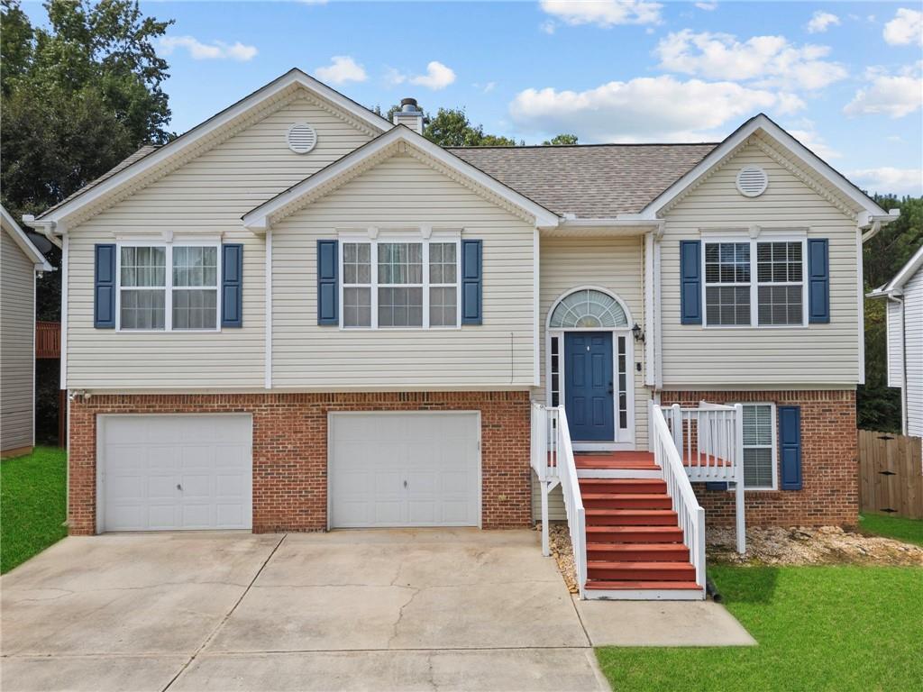 Charming 4BR/3BA home perfectly located just minutes from downtown Dallas & US-278! The open layout welcomes you with a spacious living room, cozy fireplace & bright eat-in kitchen. The main level features 3 bedrooms, including a serene primary suite with dual vanities, soaking tub & separate shower. The finished lower level offers a private bedroom, full bath & garage access—ideal for guests, a teen suite, or home office. Step outside to a fenced backyard with a raised deck & gazebo-style awning, perfect for relaxing or entertaining. Recent updates include a NEW HVAC & water heater (2022) and a 6-year-old roof. Close to schools, shopping & Silver Comet Trail—this home is move-in ready!