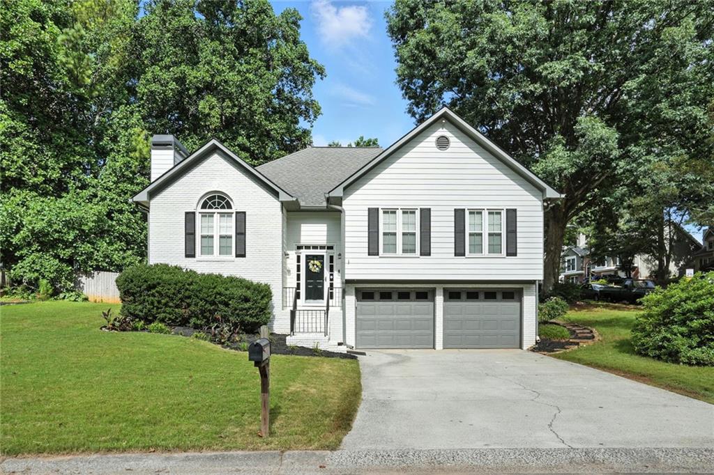 This could be your new home! Renovated with style, this charming Woodstock home is located in the swim/tennis neighborhood of Wellington Manor. Location is close to highways, shopping, schools and downtown Woodstock! Beautifully cared for this home has so much to offer: new kitchen, new master bath flooring and vanity, gorgeous hardwood flooring, new carpet in bedrooms, smooth ceilings and newer windows! Oversized fireside great room with vaulted ceiling and large Palladian window. There is also a formal/open dining space adjoining great room. Completely renovated kitchen filled with natural light and views of the fenced back yard. The kitchen offers a generous eating area with built-in window seats, white cabinets, stainless appliances, granite counters and a pantry! Lavish master suite features custom trim work, a tray ceiling and generous walk-in closet. Large secondary bedrooms and updated hall bath with granite vanity. Lower level offers a movie/second family room, a game room or man cave and tons of storage. There is workshop (could be a gym, wine cave, make it what you need) in the oversized garage. This is a fabulous floor plan. Rear yard has a large storage shed for garden tools, or would make a great playhouse. Plenty of garden space for growing vegetables and flowers. This is a must see home. Available for a fast closing.