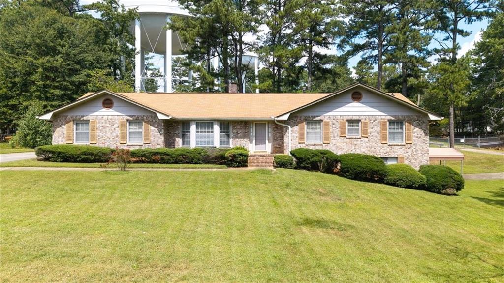 This fabulously constructed brick ranch - with just one owner in over 30 years - features a basement with full second kitchen, main level laundry, a fantastic yard, and an additional separate 2-car garage (not counted in the listed measurements) which can easily be converted to a workshop, gym, home office, band rehearsal space, etc. It's on an exceptional .7 acre lot in a highly rated school district just waiting for your contractor, builder, or architect! And, as a bonus, enjoy a spectacular unobstructed view of a City of Roswell water tower! Yes, it's like living next to the Washington Monument (except it's a water tower). The water tower does not throw loud parties, does not dump ciggy butts on your side of the fence, and does not fly politically charged flags. She is a great neighbor!