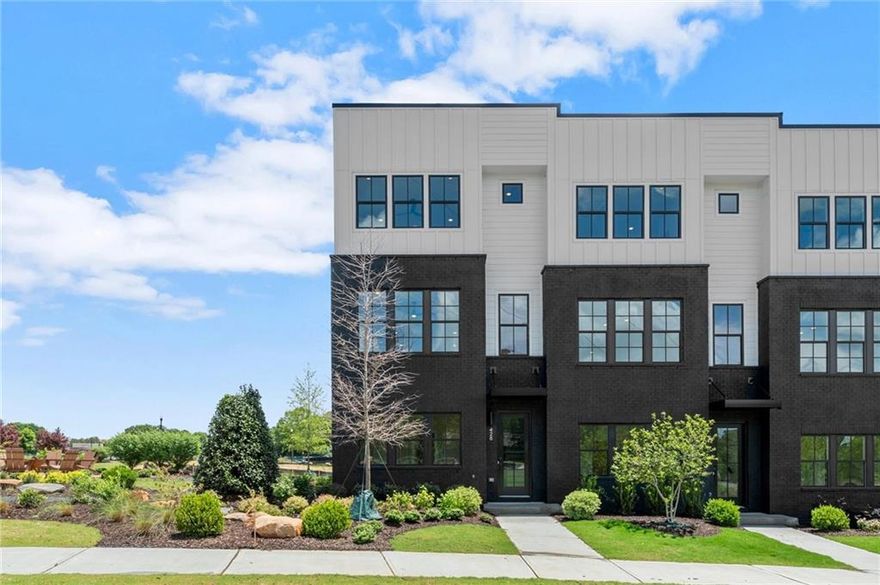 Introducing the Adeline, a Contemporary style townhome boasting 2,160 square feet of luxurious living space. With 4 bedrooms, 3.5 bathrooms, and three stories of thoughtfully designed interiors, this home offers the perfect blend of modern style and comfort. As you enter the first floor, you'll find a spacious guest suite complete with its own private bathroom, ideal for visitors or a home office. The entryway also provides access to the attached two-car garage, ensuring convenience. Ascend to the second floor to experience the heart of the home, an open concept living area designed for both relaxation and entertainment. The expansive living room, featuring 10 ft ceilings and large windows, seamlessly flows into the dining area and gourmet kitchen. The kitchen is a chef's dream, boasting Kitchen Aid stainless steel appliances, quartz countertops, sleek cabinetry and a generous island. The third floor is dedicated to privacy and tranquility housing the primary suite and additional bedrooms. The luxurious Primary Suite features a walk-in closet and spa-like en-suite bathroom with a raised maple dual vanity and glass enclosed shower. Two additional well-appointed bedrooms share a stylish full bathroom, and a laundry room on this floor adds to the home's functionality. Located in The Gathering, a Vibrant new community, just minutes from downtown Alpharetta, Avalon and top-rated schools as well as prime access to the Alpha Loop. Enjoy our community amenities such as a Community Garden, Firepit and Dog Park. This home provides the ultimate in modern suburban living. Experience the perfect combination of style, comfort and convenience!! This home is an end unit and is MOVE-IN READY!!  Agent is on-site Monday, Tuesday, Thursday, Friday & Saturday (10:00-5:00) and Wednesday and Sunday (1:00-5:00). Photos are a representation of floorplan, design is very similar, but selections may vary. Exterior color varies slightly.