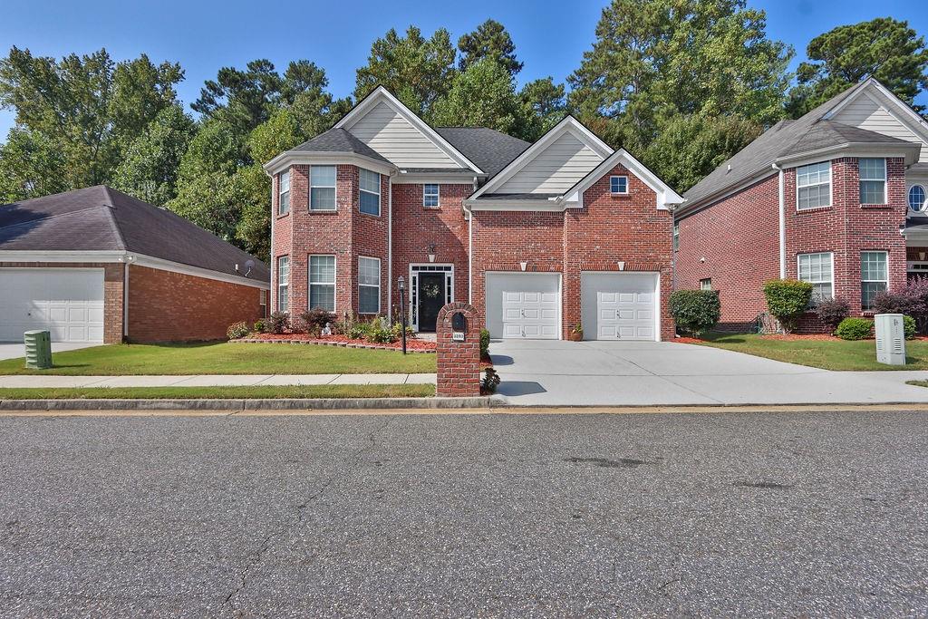 Welcome home to this meticulously maintained 4 sided brick, 4-bedroom, 2.5-bath home with a spacious layout. The main floor features a large open kitchen with beautiful wood cabinetry, a central island that opens to the breakfast area and living room with a cozy fireplace. There is also a separate dining area and an additional living room. Upstairs, the primary suite offers plenty of space with two walk-in closet and a private bath with a soaking tub and separate shower. Three additional bedrooms are generously sized, each also with walk-in closets, providing flexibility for guests, storage, or work-from-home setups. The roof was replaced less than 2 years ago. Buyers will enjoy the stone patio in the back to relax outdoors in an established community. Conveniently located near I-78, and I-85 and I-285, this home is just minutes from shopping, restaurants, and parks.