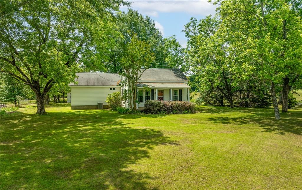 HVAC replaced 2022, New Water Heater, Septic replaced in 2016. New Windows, Termite Service until Oct 1, 2025. Step into timeless charm and modern comfort with this beautifully renovated farmhouse nestled on 1.375 acres located in Loganville. This homes classic character has been retained by blending the updates with some of the original materials of the home. Enjoy the spacious layout that includes a mudroom and laundry room and a large back porch perfect for relaxing or entertaining. The updated kitchen and bathrooms provide modern conveniences while honoring the homes's original charm. Outside you will find a detached garage mature trees and plenty of room to garden, play or expand. Don't miss the chance to own this unique slice of Loganville-schedule your showing today!