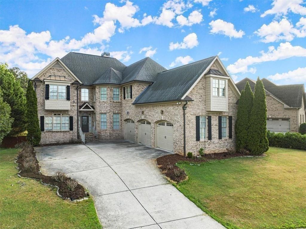 Experience the luxury of spacious living and income-generating opportunities at this stunning brick home, nestled in the sought-after subdivision of Registry at Old Lost Mountain. This freshly painted home offers both comfort and modern amenities, including a cozy double-sided fireplace, a bedroom and full bath on the main floor ideal for guests or multi-generational living, dedicated office space, a formal dining room, and two living areas. The huge kitchen features stainless steel appliances, granite countertops, a double oven, and a massive island that opens to the breakfast area and second living area. The second floor boasts an expansive master bedroom with sitting area, a luxurious master bath with his/her vanities, a separate tub and shower, an enormous master closet. Second floor as features a dedicated movie room or loft space for entertainment. Each bedroom has immediate access to a bathroom for exceptional convenience. Additional amenities include two brand new HVAC systems, smart lawn sprinklers, and a full, finished in-law suite basement complete with two bedrooms, full bath, full kitchen, living room, dining room, office, and storage room. The accessible entrance with a ramp in the three-car garage, level lot with a fenced-in backyard, and fantastic screened-in porch enhance outdoor living. Located in a well-kept, quiet neighborhood with amenities including a swimming pool, tennis courts, and a clubhouse. This home is in a prime location close to shopping, entertainment, restaurants, and schools, and just minutes from Truist Park, home of the Atlanta Braves, and The Battery entertainment district, as well as near Fox Creek Golf Course and Driving Range, the Silver Comet Trail, and much more. This home truly offers it all; don't miss the chance to make it yours and enjoy both luxurious living and prime convenience!