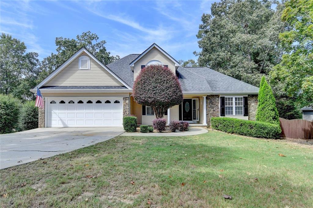 Welcome to this Charming Home just minutes away from Lake Lanier, Beautifully maintained 3-bedroom, 2.5-bath home featuring an inviting Open-Concept Layout which boasts gleaming hardwood floors, a cozy stone fireplace, and soaring vaulted ceilings, perfect for relaxing or entertaining. The kitchen is a chef’s delight with marble countertops, an L shaped island with bar seating, stainless steel appliances, a stylish tiled backsplash, and plenty of cabinet space for all your storage needs. A private sought out Primary Suite on the Main Level with other two bedrooms upstairs. Step outside and enjoy the year-round serenity in your own screened-in Sunroom, or Walk out onto the expansive party deck with an above-ground pool and fire pit overlooking your private, fenced-in backyard on over a half an acre. It’s great for gatherings, perfect for pets, or simply soaking in the sun by the pool.. Plus, an Outdoor Building to make your very own He/She Shed or a perfect place for a workshop, studio, or extra storage complete with electricity. This Home truly has it all—comfort, charm, and convenience in a prime location near Lake Lanier. Come see it in person to experience the beauty for yourself!