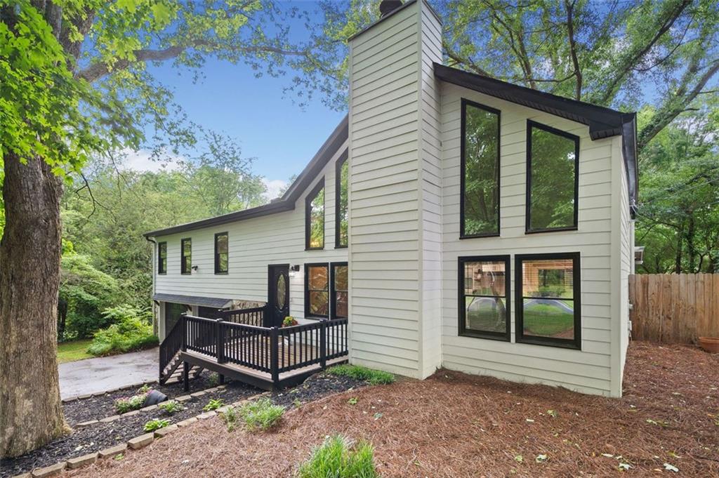 Beautiful Updated Home with Bonus Room on Large Wooded Lot -Golf Cart Distance/2.5 miles to Downtown Woodstock! This Beautiful Updated 4BR/2BA Home Offers A Flexible 5th Bedroom/Media Room/Teen Suite. Dream Kitchen Features - White Cabinets, Quartz Countertops, Tile Backsplash, Open Shelving & Stainless Steel Appliances. Eat-In Dining Area. Large-Two Story Living Room with Vaulted Ceiling Has Many Windows That Bring in Abundant of Natural Light. Large Master Bedroom. Master Bath with Barn Door, Walk-in Tile Shower, Double Vanities, Tile Flooring. His & Her Walk-In Closet with Built in Shelving. Spacious Secondary Bedrooms. Updated Hall Bath. Finished Terrace Level. Screen Porch. Huge Fenced Backyard. Large Wooded Lot. Great Schools! Quite Neighborhood! Close to Kings Academy & Cherokee Christian Academy Schools. Home is Move-In Ready! Don't Wait!