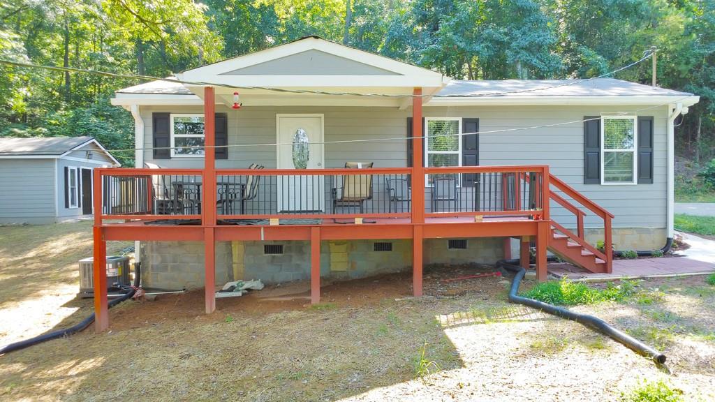 Charming and fully remodeled, this 3 bedroom / 2 bathroom ranch is perfectly tucked away on a private half-acre lot at the end of a quiet street in Silver Creek. While the original foundation was poured in 1950, this home was taken down to the studs in 2024 and was thoughtfully rebuilt with high-end finishes and modern comforts throughout. A welcoming covered front porch invites you inside, where you’ll find a cozy family room that flows seamlessly into the galley-style kitchen featuring stone counters and a sunny breakfast area. A separate dining room provides additional space for gatherings. Three generously sized bedrooms share two beautifully updated bathrooms, offering both comfort and functionality. Outside, enjoy the peace and quiet of the serene setting, complete with two storage buildings for all your needs. Conveniently located with easy access to Rome, major roadways, and a wide variety of shopping and dining options, this home combines modern updates with a tranquil lifestyle. The neighboring 3.88-acre parcel is also available, providing endless possibilities for expansion, investment, or creating your own private retreat (FMLS #7635488)