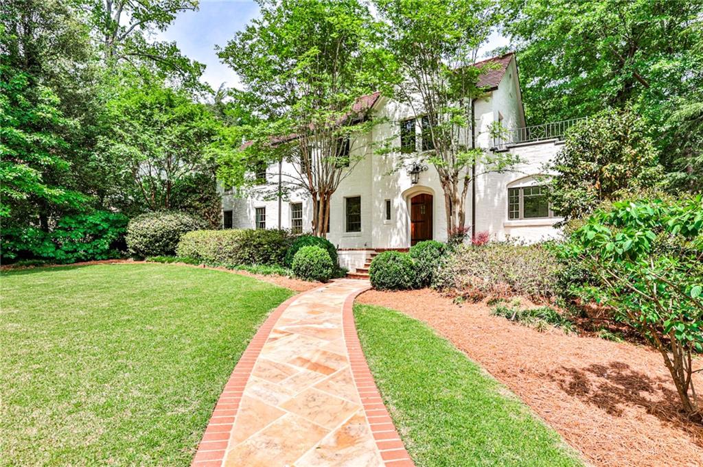 This magazine worthy Druid Hills Mediterranean home is quietly tucked off of Ponce de Leon on North Ponce de Leon Avenue between Olmsted's Deepdene Park and Fernbank Forest. Completely renovated with bright, open spaces that brings the outdoors in on an estate size lot. The main level includes a custom kitchen with double dishwashers, professional Wolf range and 2 Sub Zero refrigerators. The breakfast room overlooks the pool and carriage house. Separate dining room, study, living room and family room. Oversized laundry with double washer and dryers. Upstairs has 4 bedrooms and 3 baths including a serene owners suite. The carriage house features a drop down front wall that opens the to pool for entertaining. Kitchen and main level bath service the pool area or Carriage House guest. Bedroom or office is upstairs. Privacy is paramount in the "Secret Garden" paths that lead to the forest. This is truly a magical property!