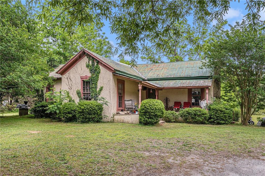 Investor’s Dream! This incredible 20-acre property offers endless potential with two homes and a creek running through the land. Located just minutes from Jackson Lake and public boat ramps at Barry’s Boat Docks, this opportunity is perfect for generating immediate income or expanding your investment portfolio.
The first home at 2249 Jackson Lake Rd is a 2-bedroom, 1-bath residence that is currently rented, providing instant rental income. The second home at 2299 Jackson Lake Rd is a 3-bedroom, 2-bath modular home featuring a charming front porch and an upgraded rear enclosed room, currently occupied by a family.
Enjoy peace and privacy while being conveniently close to historic downtown Covington Square, offering a delightful mix of shops, restaurants, and entertainment. Whether you're looking to build, expand, or invest, this unique property is a rare find. Don’t miss out on this fantastic opportunity!