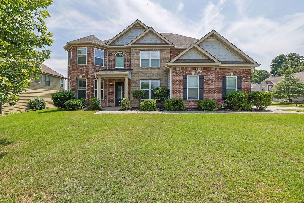 Welcome to this beautifully designed 5-bedroom, 4-bathroom home, where elegance, space, and functionality come together seamlessly. Situated on an oversized corner lot, this property offers privacy and abundant outdoor space. Step inside and be greeted by rich engineered hardwood floors that flow throughout the main level. The thoughtfully designed layout includes a formal dining room and a versatile office or additional living area. The gourmet kitchen is a chef’s dream, featuring a brand-new refrigerator, double oven, gas stove, granite countertops, a spacious island, and a cozy eat-in area with bar seating—perfect for both everyday meals and entertaining. A guest bedroom and a full bath on the main floor add convenience for visitors or multi-generational living. Ascend on either of the two staircases to the upper level, where FOUR well-appointed bedrooms and three full baths await. One bedroom features its own en suite, offering added comfort and privacy. A separate staircase leads to the impressive primary suite, complete with a private den, his-and-her walk-in closets, and a spa-like bathroom featuring dual vanities, a soaking tub, and a separate shower for a luxurious retreat. Step outside from the family room to a covered patio overlooking a serene, private backyard—an ideal space for outdoor gatherings or peaceful relaxation. Additional features include an electric car charger in the garage and a state-of-the-art camera system with motion-activated detectors for added security. This exceptional home offers the perfect combination of modern convenience and timeless elegance. Don’t miss your opportunity—schedule your private tour today!