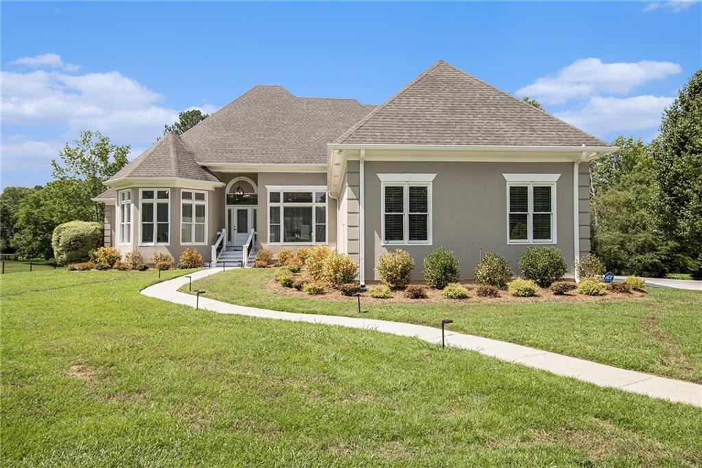 Welcome to this exquisite 5-bedroom, 5-bath custom lakeview ranch in the prestigious and highly sought-after Smoke Rise Farms—an exclusive enclave in Lithonia surrounded by million-dollar estates. This one-of-a-kind home is situated on nearly 1.5 acres of beautifully landscaped land with a full irrigation system and offers a rare combination of elegance, functionality, and flexibility.
Every home in this neighborhood was individually designed by its original owner, and this residence is no exception. Enjoy serene lake views from nearly every room, with direct access to one of two preserved lakes in the subdivision and a community gazebo perfect for peaceful gatherings. The home features two full kitchens, two fireplaces, two laundry rooms, and separate utilities—making it ideal for a multi-generational setup, a private apartment, or an income-producing Airbnb. The terrace-level suite has a private entrance and its own kitchen and laundry.
The main level showcases an open-concept floor plan with abundant natural light throughout. The chef’s kitchen is equipped with high-end stainless steel appliances, quartz countertops, an oversized island, a six-burner stove with warming area, and a spacious breakfast area. The primary suite is a private retreat with lake views, a spa-inspired bath, and a large walk-in closet. A dedicated study offers added flexibility for working from home or creating a quiet sanctuary.
The terrace level walkout is perfect for entertaining, relaxing, or adding a future pool, making full use of the expansive backyard and tranquil lake views.
This location offers unmatched access to outdoor recreation and cultural experiences. Minutes from Arabia Mountain PATH, Davidson-Arabia Nature Preserve, and Arabia Mountain Vineyard. Stone Mountain Park, Southland Country Club, and Stone Mountain Golf Club are all nearby. Dining, shopping, and entertainment are close by at The Mall at Stonecrest, and downtown Atlanta is just a short drive away.
Owner financing is available, offering a rare opportunity to purchase a distinctive lakeside home in one of DeKalb County’s most exclusive communities. Schedule your private tour today and experience luxury lakeview living at its finest.