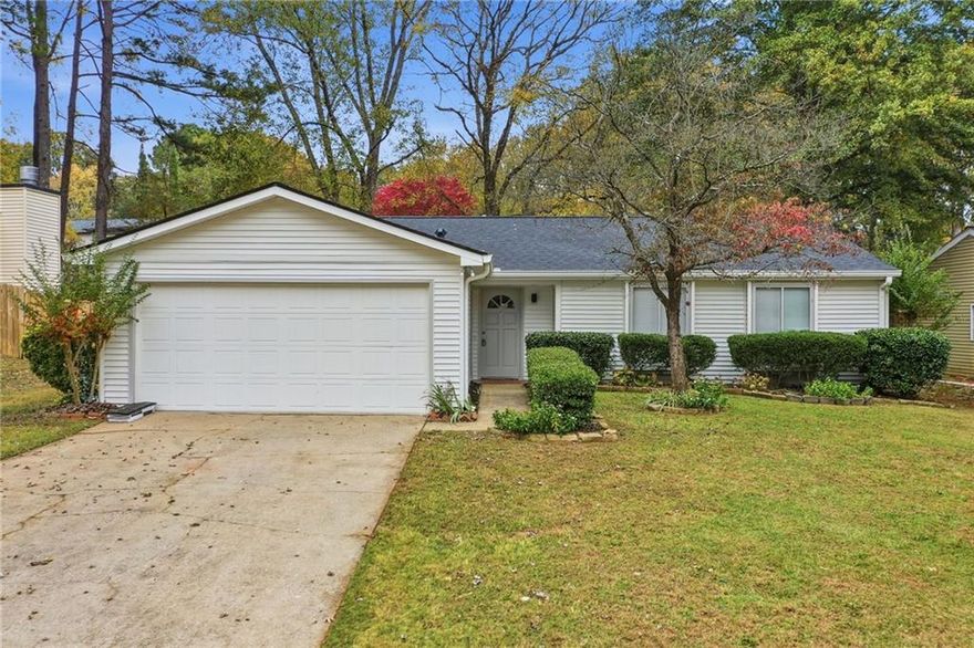 Charming, updated ranch in Roswell, GA with brand new roof. Step into the living room with a vaulted ceiling and cozy fireplace—perfect for relaxing. The kitchen features crisp white cabinetry, stainless steel appliances, stone countertops, and a tiled backsplash. The primary suite offers a private retreat with a fully renovated en-suite bathroom, luxurious shower, updated vanity, and trendy black hardware. The second bathroom has been similarly updated. The fenced backyard includes a covered patio, ideal for pets, relaxing, or entertaining. Additional features include a side patio and a two-car garage