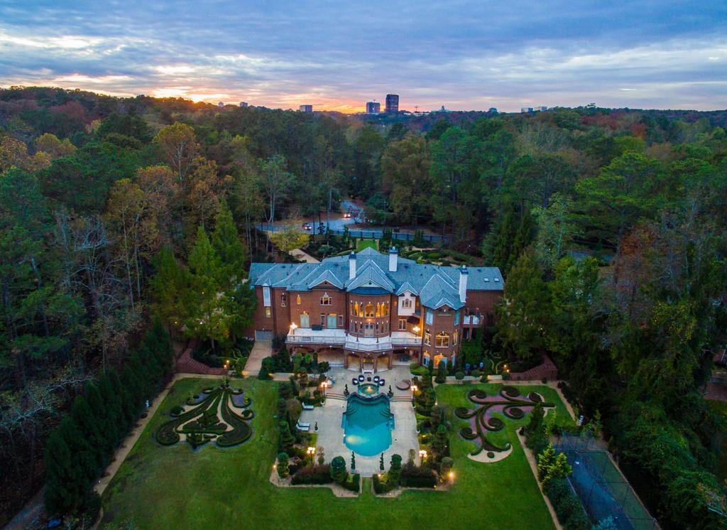 Conceived for entertaining on a grand scale, this exquisite estate beckons at Chateau De L’Imaginaire. Poised for future filming opportunities, your estate has already had a starring role in many Hollywood productions. The interior and exterior beg to be shown-off, from manicured gardens designed by an internationally-acclaimed landscape architect to the lavishly sprawling inside. For the avid collector, a 25-car motor court and 6-car garage are ideally-suited for putting your collection on display. A grand entry and two-story great room/ballroom will awe your guests from the moment they arrive. Two commercial-grade kitchens keep guests sated, yet also function beautifully for everyday living. Relish Atlanta's temperate climate from your magnificent outdoor space and admire the artful beauty of the landscape. A gorgeous saltwater pool surrounded by a resort-style sundeck is a perfect setting for alfresco entertaining. With a sought-after location in the affluent Buckhead community, not to mention close proximity to Whitewater Creek Trail for pristine hiking, biking, and walking paths, 4455 Harris Trail NW is one of Atlanta's most luxurious estates.