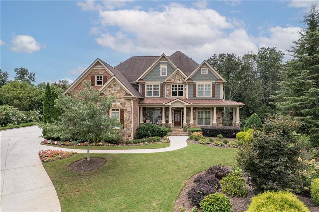 Luxury and lifestyle converge in this meticulously maintained 5BR/4.5BA, 3-car garage Lake Forest home, nestled on a 1.65-acre cul-de-sac lot—one of the largest and flattest in the community. Features include: refinished hardwoods, gourmet kitchen with oversized island (wine fridge-ready), two gas-starting wood-burning fireplaces, and fresh paint inside & out. The expansive flagstone rocking chair front porch welcomes you HOME! The main level offers a dedicated office, large dining room, keeping room, half bath, family room with built in's, and a spacious guest bedroom with adjacent full bath. Upstairs: The spacious layout includes a grand primary suite with sitting area, spa-like en suite bath, and enormous closet space. An additional en suite bedroom offers privacy for guests or family, while the remaining two bedrooms share a Jack-and-Jill bath. Large flex space for game room or private living space completes the upstairs. Outdoor living at its best with a large deck, large flat fully fenced back yard, flagstone fire pit area with paved pathway, hot tub on a large stamped concrete patio. tankless water heater, and fully stubbed basement ready for your vision. Enjoy resort-style community amenities: zero-entry pool with cabanas, clubhouse, tennis & pickleball courts, basketball, playground, beach volleyball, and a lake park with fishing dock and non-motorized boat launch. Luxury living, family comfort, and unparalleled amenities all in one.