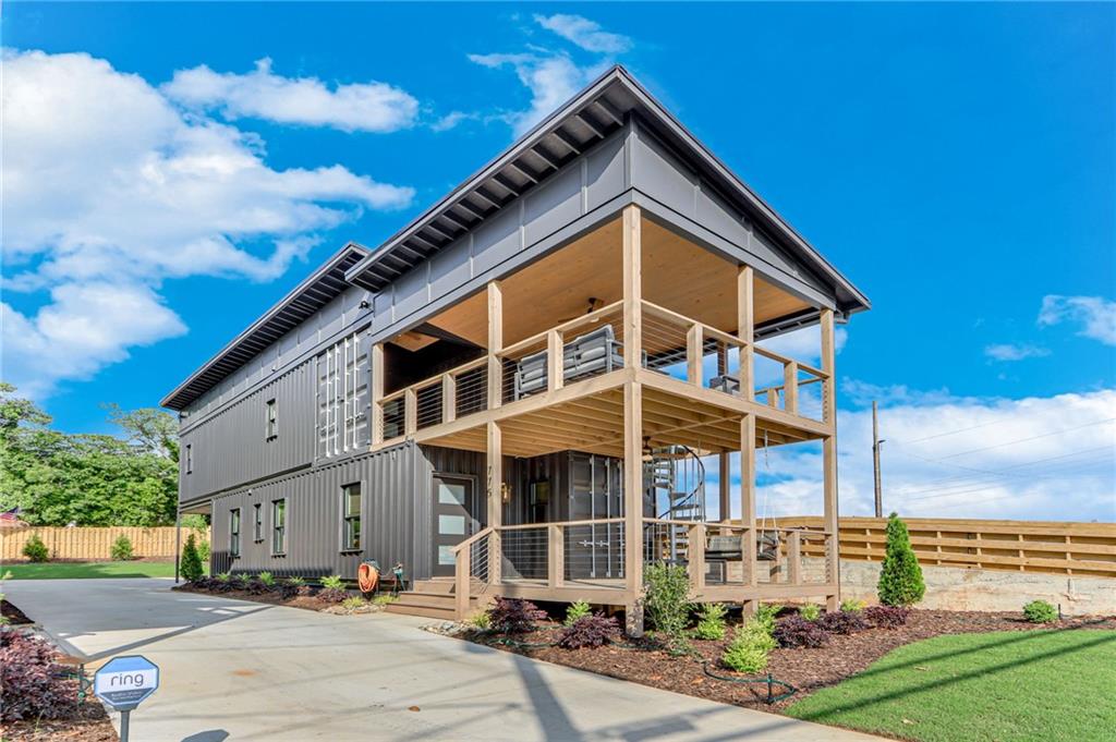 Modern. Bold. Completely one-of-a-kind—right in the heart of Midtown Gainesville. Step into this brand-new, fully furnished container home and experience a rental like no other. With 2 bedrooms, 2.5 bathrooms, top-of-the-line appliances, stylish furnishings, and all utilities included, this home is move-in ready with zero hassle. The open layout flows effortlessly to the main level deck—perfect for morning coffee or grilling out. Upstairs, the primary suite offers a private deck for winding down in peace, plus a third deck gives you even more room to relax or entertain. Just steps from local breweries, restaurants, parks, and everything Midtown has to offer. No hidden fees. Just smart design, great location, and seriously good vibes.