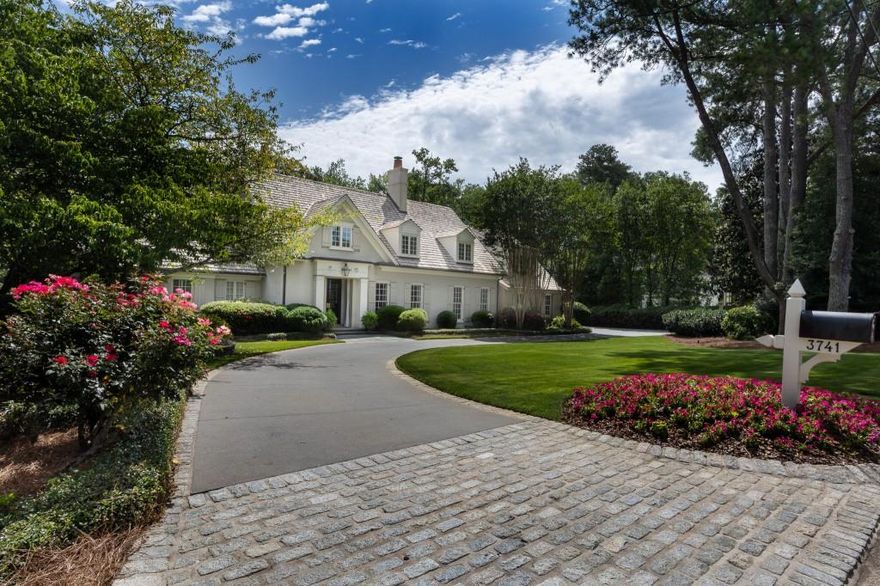 Exquisite Kingswood Estate Nestled in the highly sought-after Kingswood neighborhood, this stunning 5-bedroom, 5-bath residence designed by the acclaimed Spitzmiller & Norris offers timeless elegance and modern comfort. Ideally located close to Atlanta's premier private schools, the home combines classic architecture with thoughtful design and luxurious finishes. Enter the custom designed front entrance with a custom Bevolo lantern and new double iron doors with gold hardware accent. . From the moment you step inside, you are greeted by reclaimed wide plank heart of pine floors, custom millwork, limestone fireplaces and antique light fixtures that add warmth and character to every room. The home is filled with high-end custom finishes throughout, creating a refined yet comfortable living environment. This home was completely renovated in 2005 including taking the original home down to the studs, expanding the footprint and re-imagining modern living while preserving charm with a emphasis on quality and elegant sophistication. The main-level primary suite with a large bay window provides lovely views to the backyard while the upper level features four bedrooms, three baths, and a spacious vaulted family room. Other features included on the main level are custom lockers with brick floors, living room lined with iron doors, Rocky Mountain high end hardware, Marvin windows, dining room with fireplace, library with iron doors opens to stone terrace, home office, large oversized bar and oversized pantry and laundry. Walk out from the family room to a large stone terrace with an inviting pool elevated over an enormous flat backyard. There is also a pool house with a full bath and fireplace make entertaining effortless. This home was designed with an ability to entertain inside and out. The flow from the main house to the beautiful terrace, pool and pool house is seamless. Outdoor moonscape lighting along with lighting around the trees on stone terrace create a magical outdoor atmosphere. This exceptional property is a rare opportunity to own a truly custom home in one of Atlanta's most prestigious neighborhoods.