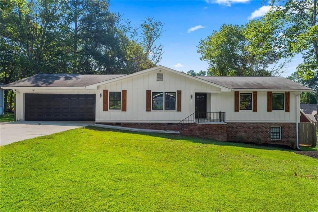 Fully renovated ranch in Lawrenceville with 3 bedrooms, 2 bathrooms, and an oversized bonus room across 2,034sq ft on the main level, plus 1,591sq ft of unfinished basement space with exterior door. The open floor plan includes a living room with wood-burning fireplace and abundant light, dining area, and gourmet kitchen with Shadow Storm marble countertops, oversized island, farmhouse sink, stainless appliances, and open shelving. The spacious primary suite features great natural light and a modern updated bath with walk-in marble shower and custom vanity. Two additional bedrooms share a beautifully updated hall bath. An expansive bonus room with soaring ceilings and backyard access is ideal for a media room, office, or playroom. The backyard offers turf grass seating area and a large grass space for entertaining or gardening. Additional Updates include two HVAC systems (2023), water heater (2021), roof (2020), fresh paint, epoxy garage floor, and French drain, and much more. Convenient to top Gwinnett County Schools, Hwy 316, I-85, downtown Lawrenceville, shopping, and parks. Don’t miss your chance to own this stunning property—schedule your private tour today!
