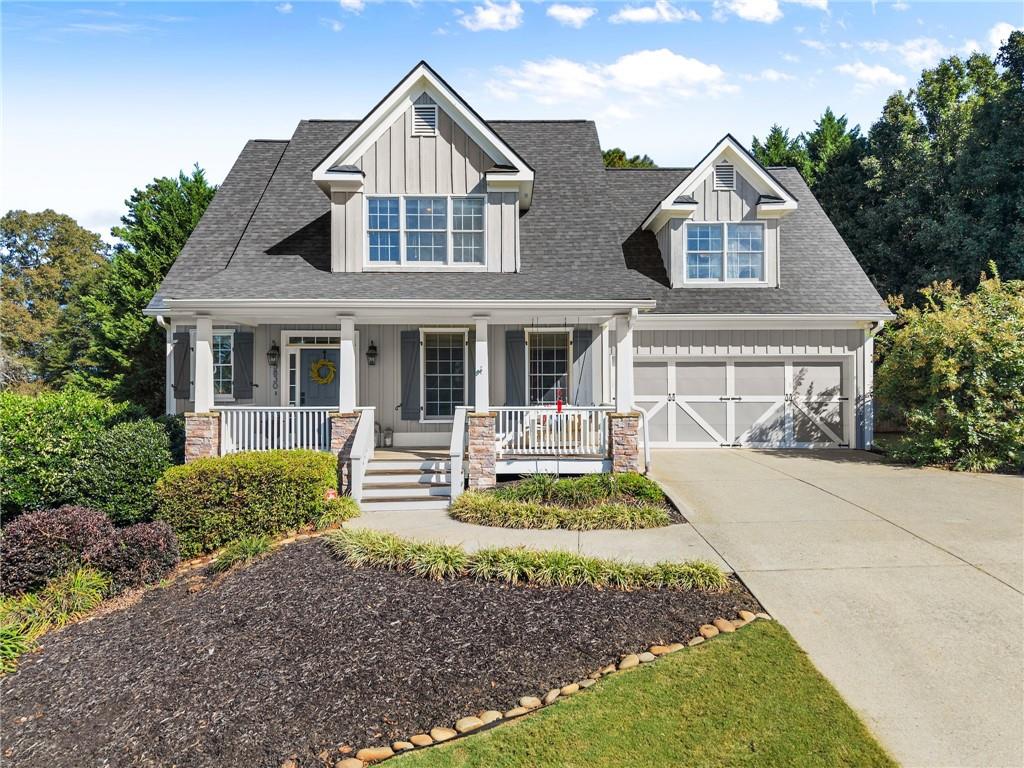 Discover the perfect blend of space, style and ultimate convenience in this stunning 5-bedroom, 3.5-bathroom home, nestled on a private, fenced half-acre lot.
From the moment you step inside, you'll be captivated by the sun-drenched, open-concept layout. The soaring vaulted ceilings in the family room create a sense of grandeur, while shiplap accent walls and gleaming hardwood floors add a touch of modern farmhouse charm. The heart of the home is the beautiful kitchen, featuring modern appliances that flows effortlessly into the great room. Picture yourself cozying up by the fireplace on cool evenings or hosting memorable gatherings with friends and family. Upstairs, three additional spacious bedrooms share a convenient Jack & Jill bathroom, providing plenty of space for family and guests. The finished terrace level offers incredible flexibility—a private guest suite with a bedroom and full bath, plus a versatile flex space perfect for a home theater, gym, or remote office. Your living space extends outdoors to an oversized back deck, the ideal spot for summer barbecues and relaxing afternoons overlooking your peaceful, fully-fenced backyard. Situated in a prime location near top-rated Forsyth County schools, this home offers unparalleled access to the best of the area. Enjoy effortless shopping sprees and find your favorite brands at the North Georgia Premium Outlets along with a world of dining, entertainment, and everyday conveniences, all within a short drive! This home is the complete package. Schedule your private tour today and prepare to fall in love!