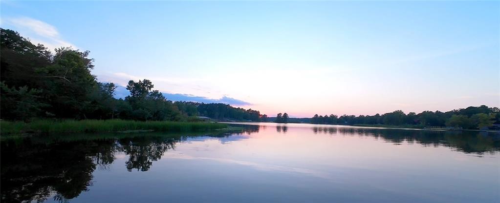 The Classic A frame in the woods, on over 100' of shoreline and the treat of an incredible sunset every evening. This cabin offers the privacy and fun that make being at the lake exactly where you want to be. Holiday Shores offers some great amenities, like a neighborhood boat launch, clubhouse, pavillion and Pickleball courts. Its a friendly neighborhood with lots of social events (see the recent Jet Ski Dock Poker tournament) and a great mix of full time and part time owners. The large deck has just been restained and is ready to be the center of the social scene for you and your friends. The freshly painted interior, new windows, and recent HVAC replacement mean you have a blank canvas to put your personal touch on this home, or ignore it and go out and play! All furniture and furnishings in the home to remain (except bed in upstairs lake side BR) so you won't have to go get new furniture to enjoy your new fun pad. The enormous drive under basement is plenty of space to store all of your toys. The feeling of being in the woods and having the occasional bonfire will make you want to pick up the guitar. Come out and take a look. We bet you'll never want to leave.