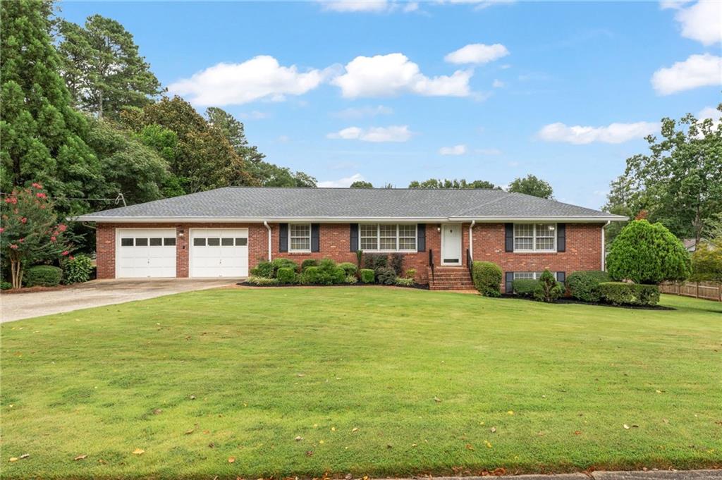Charming 4-Sided Brick Ranch, 2-Car Garage, with a full daylight basement on this lovely spacious corner lot. Come see this beautiful 3-bedroom, 2-full bath home located in the most highly desirable Whitlock Heights Subdivision. You are approximately 8 minutes from near Historic Marietta Square. This handsome ranch home is ideally located in a well-established Marietta neighborhood with multiple points of entry and exit, to make commuting more pleasant. It's within walking distance of Hickory Hills Elementary School and Tumlin Park. This house has brand new architectural shingle roof installed in 2024 with a transferable warranty covering manufacturer's defects and workmanship. The Air Conditioner was installed in July 2025 with a transferable warranty. New recessed lighting and ceiling fans throughout. Hardwood floors run throughout the home. Tile runs through the lovely, updated kitchen with eat-in kitchen that includes ample cabinetry extending into a spacious laundry room. Kitchen has all modern updated appliances with under counter lighting and granite countertops. Enjoy breakfast in the eat-in kitchen or out on the large screened-in back deck while overlooking the huge backyard and established landscaping. The large living room can be a living and dining room combo. Spacious den/keeping room has a beautiful brick fireplace with newly installed hardwood floors. Three large bedrooms, living room, dining room on the main level all have original hardwood flooring. Fresh paint throughout the house, including the basement, 2-car garage, newly installed deck, screened porch, and exterior. Downstairs is an unfinished daylight basement with a second brick fireplace which is a blank canvas for additional living space or storage. This is a well-loved home that features an additional 1-car garage/outbuilding featuring a garage door and side entry, also with a new
roof installed in 2024. The location of this home makes it easy to see why this neighborhood has stood the test of time with easy access to the vibrant shops, restaurants, and events of the conveniently located approximately 2.2 miles to beautiful Historic Marietta Square.