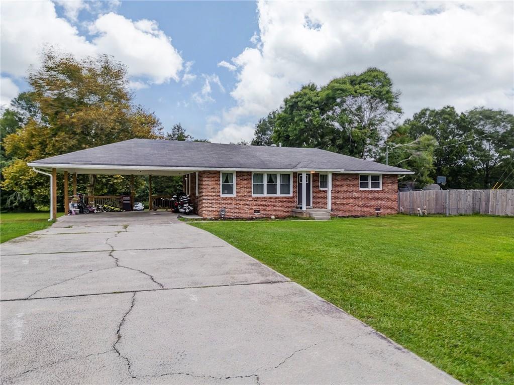 This charming country home offers a warm welcome just minutes from shopping, dining, and the heart of Cedartown. Step inside to find rich hardwood floors and an airy open-concept design that blends the living area, dining room, and kitchen seamlessly. Crisp white cabinetry adds a bright, timeless touch to the kitchen, creating a perfect space for cooking and gathering.
A spacious primary suite on the main level provides a peaceful retreat, while additional bedrooms are comfortably arranged for versatility. Large windows throughout bring in natural light, enhancing the home’s inviting feel.
Out back, a covered porch overlooks a private yard—ideal for enjoying morning coffee or unwinding in the evening. With its thoughtful layout, classic finishes, and convenient location, this residence delivers both comfort and connection to all the area has to offer.