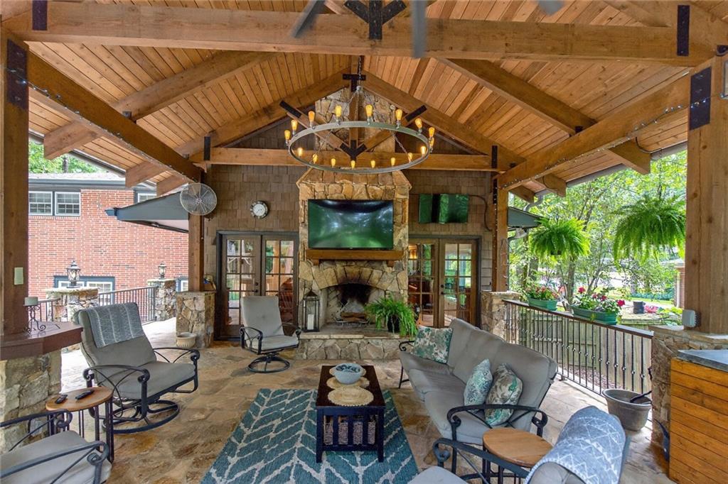 Welcome to this beautifully maintained home in the ever-popular Briarmoor Manor neighborhood. Set on a little over .50 acre of landscaped grounds with four season blooms, this property is designed for comfort, entertaining, and everyday living. The flexible first-level suite offers a spacious bedroom with walk-in closet and en-suite bath—ideal as a primary retreat or private guest quarters. A large laundry room is also conveniently located on this level. The main floor features a light-filled living room, dining room, updated kitchen, powder room, and a generous fireside family room perfect for gatherings. Upstairs you’ll find three additional bedrooms and a generously sized bath. The true highlight of this home is the incredible outdoor living space. A commercial-grade "mountain lodge" porch off of the fireside family room boasts soaring 16-foot ceilings, a stone fireplace, three zones of lighting, dual TV setup, and a full outdoor kitchen complete with a 6-burner Napoleon Professional natural gas grill, side burner, wine fridge, and natural gas heater—just in time for football season. A 6-person Jacuzzi hot tub with UV filtration system adds year-round relaxation, while the 10x10 playhouse and expansive parking for 10+ vehicles (or RV) make entertaining easy. Additional features include a large woodworking workshop with 20Amp and 220V sub panel, encapsulated crawl space with dehumidifier, and double-pane windows throughout. Briarmoor Manor offers a neighborhood pool with a swim team, and the location provides quick access to I-85, I-285, Emory, CDC, Oak Grove Village shops, restaurants, and parks. This home blends space, function, and lifestyle—ready to welcome its next owners.