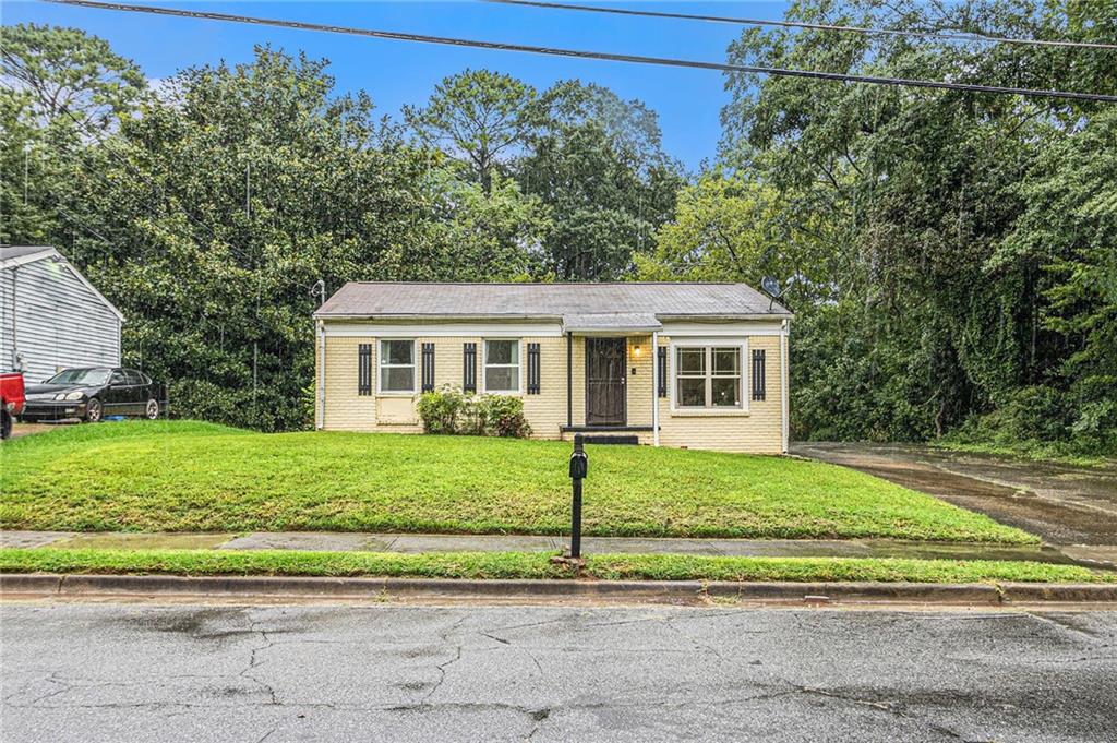 Charming 3-bedroom, 2-bath brick-front bungalow nestled on a spacious 0.50-acre lot! This inviting home offers covered front porch, Inside a warm and functional layout with a cozy living area, a spacious kitchen, and generously sized bedrooms. The primary suite includes a private bath for added comfort. Step outside to enjoy the expansive yard perfect for gardening, outdoor entertaining, or future expansion. Conveniently located with easy access to shopping, dining, and major highways, this home blends comfort, charm, and room to grow!