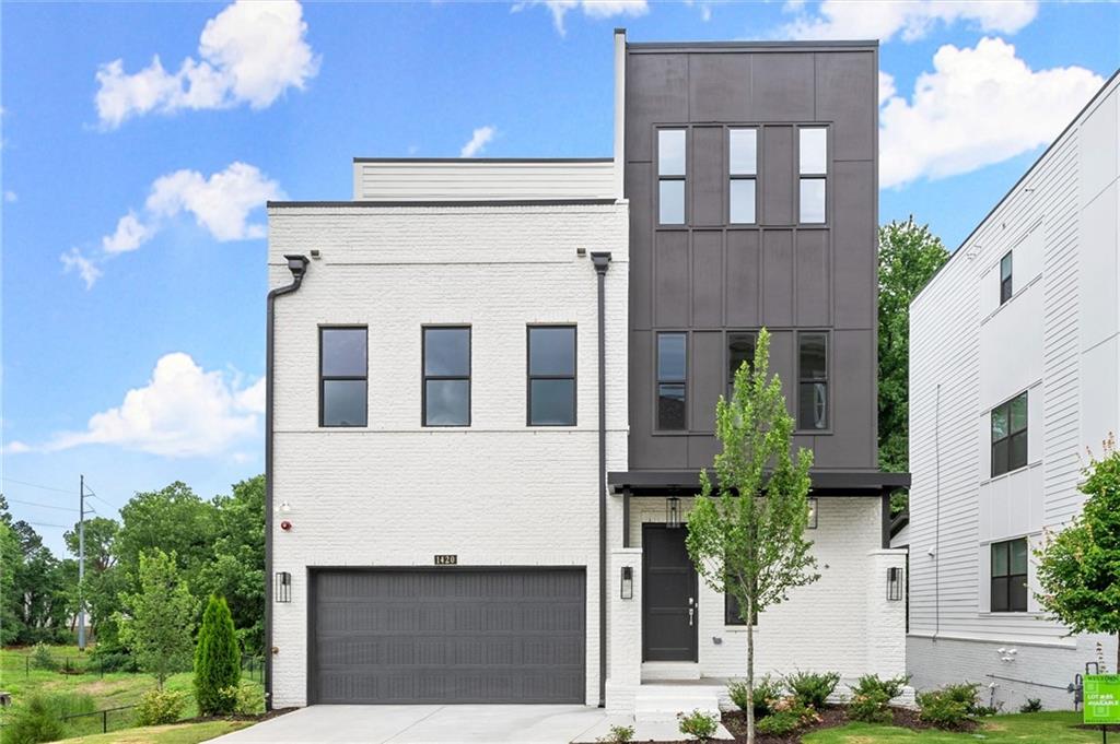 Experience the pinnacle of urban luxury living with the Edgemont plan, a stunning corner-lot residence offering sweeping views of the iconic Atlanta BeltLine. This exceptional home, situated at the end of a peaceful cul-de-sac, boasts a coveted 800-square-foot rooftop terrace—ideal for both relaxation and entertainment—with the added luxury of a fireplace. Enjoy the warmth and ambiance of the fire while taking in breathtaking views, as well as the privacy of mature trees enveloping the expansive rear covered deck.
This residence is designed for both functionality and elegance, featuring 3 generously sized secondary bedrooms, an oversized primary suite, and an elevator that effortlessly connects all four levels, enhancing convenience and accessibility.
Step inside to discover an abundance of natural light, gleaming hardwood floors, and soaring 10-foot ceilings throughout. The Grand Chef’s kitchen is a showstopper, with a stunning quartz waterfall island, ceiling-height painted white cabinetry, and premium KitchenAid industrial appliances, all designed to inspire your culinary creativity.
Relax in the family room, where the warmth of a white brick fireplace with a cedar mantle creates a cozy yet sophisticated ambiance. Alternatively, step out onto the oversized second-floor deck, where you can escape the city hustle and enjoy serene outdoor living.
The rooftop level is a true retreat, featuring a bedroom, a full bath, a wet bar, and a Western Door leading to the covered terrace, complete with a fireplace—perfect for unwinding with a glass of wine as the sun sets.
This home is move-in ready, offering a seamless blend of modern design and unparalleled convenience. Visit West Town today to tour this breathtaking Brock Built home and elevate your lifestyle.