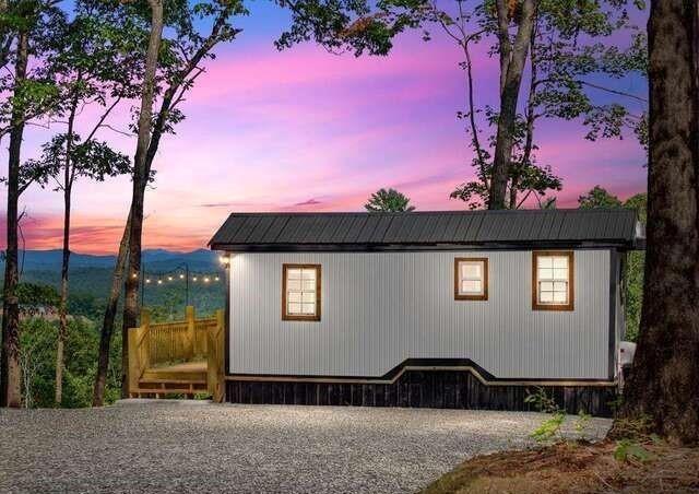 Turnkey Short-Term Rental with Stunning Mountain Views & Proven Passive Income!
Don’t miss this rare opportunity to own a highly-rated, fully furnished short-term rental with a consistent track record of bookings and rave guest reviews. This charming tiny home sits on a private acre with unobstructed 180-degree views of the beautiful Blue Ridge Mountains—perfect for relaxing getaways or income-generating investment. Guests love the spacious deck featuring a grill, café lights, fire pit, and peaceful stargazing. Inside, you’ll find a cozy, thoughtfully designed space with an electric fireplace, sleeping for 3–4, and a kitchen equipped with everything you need—including a refrigerator, microwave, and icemaker. Whether you're expanding your portfolio or seeking a mountain retreat of your own, this property is ready to perform from day one. No HOA, strong rental history, and minutes to hiking, wineries, and charming mountain towns!