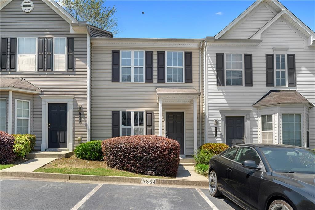Come see this beautifully updated townhouse located in the gated Arbor Gate community. The main level offers an open-concept layout, seamlessly connecting the kitchen, dining, and living areas—perfect for both everyday living and entertaining. The kitchen features crisp white cabinetry, stone countertops, stainless steel appliances, and stylish black hardware for a modern touch. The spacious living room feels warm and inviting with a cozy fireplace as its centerpiece. Upstairs, you’ll find two generously sized bedrooms, each with its own updated ensuite bathroom featuring new vanities. Fresh paint and new flooring throughout the home give it a clean, modern feel—ready for you to move right in.