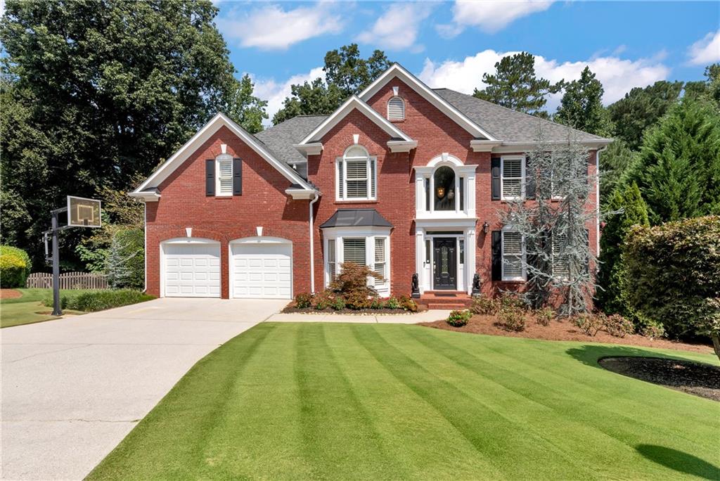 Welcome to 1502 Mill Grove Court situated on one of the most manicured lawns in Hamilton Mill. This home sits nestled on a cul-de-sac with your own private oasis - inground saltwater pool, screened back porch and outdoor space perfect for entertaining with family and friends. This well-appointed home greets you with a formal living room perfect for a home office and separate dining room. Amazing kitchen has been completely renovated with new high-end custom cabinets complete with soft-close drawers and multiple pullouts, gorgeous quartz counters and farmhouse sink - no detail was missed! Just off the kitchen is a spacious fireside family room with built-in bookcases and a soaring palladium window with gorgeous views of the private yard. Guest Bed with full bath complete the main level. Make your way upstairs from the dual staircase to find three additional guest bedrooms with adjoining bath and separate private ensuite. Spacious Primary Suite and updated spa-like bath with gorgeous tile surround, soaking tub and two large walk-in closets. Full finished basement offers tons of space and is already wired for your home theatre. Workshop, Plantation shutters, and much more! Great schools and close to shopping. Hamilton Mill community offers resort-style amenities which include golf, pickleball, swim, tennis, playgrounds and more! The surrounding area boasts beautiful Little Mulberry Park, easy access to I85, shopping, restaurants, and sought after Mill Creek schools.