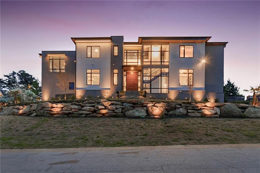 A modern masterpiece of distinction. Nestled on a 0.75-acre corner lot one of the largest lots within the prestigious Indian Hills Country Club and located in the highly sought-after Walton High School district. A stunning curb appeal, sleek Casement windows, featuring wood-look panels, architectural lighting beautifully manicured lawns, and impeccable attention to detail. This home offers an array of exceptional features, seamlessly blending opulence, innovation, and comfort on each level even to the most meticulous buyer. Progress through the grand pivot door into the soaring ceiling foyer and family room adorned with premium sophisticated chandelier lighting, mesmerizing built ins and fireplace. Dramatic floating staircase, with motion sensor lights, setting the tone for the sophistication and elegance that awaits. State-of-the-art kitchen features, exquisite stunning cabinetry, Quartzite waterfall countertops, commercial-grade appliances that ensures an immersive entertainment experience complete with acoustic wood panels. The adjacent scullery provides the perfect setup for hosting gatherings and events. The living space expands effortlessly outdoors through sleek nano accordion doors, connecting to a cozy outdoor. Unwind in style in the expansive primary suite, complete with bespoke closets and a lavish resort-style bathroom featuring a stunning stone soaking tub. Additional bedrooms are equally impressive, boasting generous proportions and private en-suite bathrooms. For added convenience, two spacious laundry rooms are strategically located on both the main and second levels, featuring custom cabinetry for effortless organization. This residence boasts a stunning terrace level perfect for entertaining, complete Wine cellar,  a media room, state-of-the-art glass-enclosed gym, fully equipped sauna, lounge, family room, powder room, and a beautifully appointed guest suite with a court yard. Additional features include a convenient three-stop elevator and expansive Four-car garage. The outdoor space truly conveys the ultimate resort style and tranquility featuring a cabana, fire pit , saltwater pool and rejuvenating spa with a stunning waterfall feature overlooking the lush green yard. Indian Hills Country Club features a 27 hole golf course, newly renovated clubhouse, 8 tennis courts and 3 pools. Conveniently located near Shopping, Parks, Public and Private Schools.