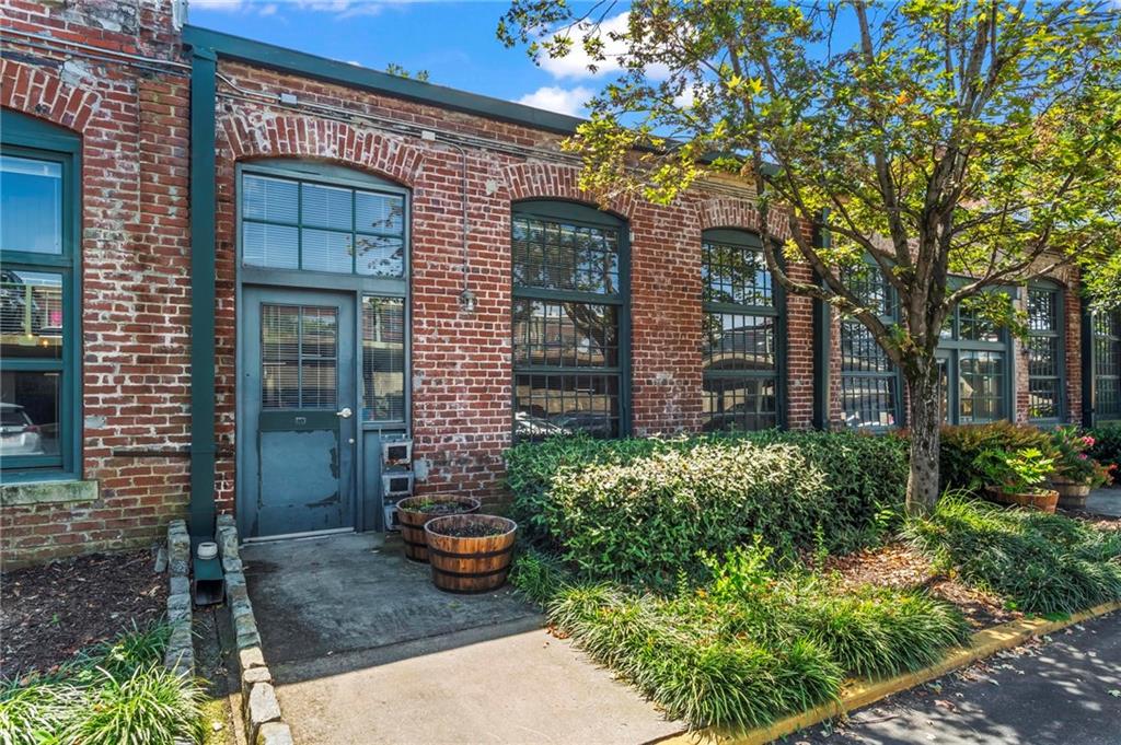 This charming condo is located within the stunning, gated community of The Stacks, which is situated in the heart of Cabbagetown. This spacious studio blends historic charm and modern living with soaring 15-foot wood-beamed ceilings, two story windows, and exposed brick walls. The bright and open kitchen features stainless steel appliances, including a new oven. The open-concept layout flows seamlessly into the living area, where there is a projector with a retractable screen, allowing you to turn the space into a home theater at the touch of a button. The unit also has exceptional storage in the combined walk-in closet and laundry room, equipped with stackable Whirlpool washer and dryer units.
This unique unit has many great features and upgrades including Lutron light switches that can be controlled from an app or by voice with Google Chromecast and Alexa, high speed internet with Google Fiber, floors that have been redone, a newer water heater, ample amounts of natural light, an assigned parking space (#148) located just steps away from the front door, and private outdoor access to your unit. Additionally, the current owner has installed a new smoke detector, upgraded light fixtures and ceiling fans, a coat rack, bathroom shelves, a Google Nest and security cameras.
The highly sought after Stacks community offers fantastic amenities, including a remarkable pool, a fitness center only accessible by owners, rooftop decks with amazing views of the city, multiple courtyards, dog parks (small and large), and 24/7 security at the front gate. It’s an extremely walkable location - just minutes away from the Atlanta Beltline, Fetch Park, Cabbagetown Park, the King Memorial Marta Station, as well as fantastic restaurants including Carroll Street Cafe, Agave, Edgewood Pizza, Insomnia Cookies, Grindhouse Burgers, and so many more. In addition, access to I-20, I-75, and I-85 is just a short drive away.