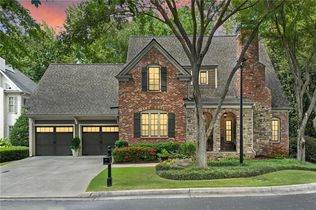 Wow! Don't miss the opportunity to make this move-in-ready 5 bedroom, 3.5 bath craftsman/traditional home in the desirable private gated Alpharetta community of Woodvale your own! This fabulous primary-on-main, 4-sided brick and stone home features gleaming hardwoods, luxurious 10 ft ceilings and open-concept floor plan on the main level, and custom finishes throughout! The main living level includes a separate formal dining room— perfect for a home office, spacious eat-in kitchen complete with custom cabinetry, stone countertops, stainless appliances, and adjacent breakfast area, all open to the striking two-story vaulted fireside family room that overlooks the lush tree canopy of the backyard! Additionally on the main level, you’ll find the oversized primary bedroom with gorgeous cozy fireplace, large walk-in closet, and beautiful ensuite bath with double vanity, walk-in shower, and separate jetted tub. Upstairs, you’ll find four sizable guest bedrooms— one that could be used as an additional primary suite, as well as two guest bathrooms. The partially finished walk-out daylight terrace level offers a large multi-purpose space and is stubbed for bath— ready to create a fantastic private guest suite if desired! Outside, you’ll find two convenient decks off of the main level— one covered and perfect for grilling or just relaxing in the shade, and the other uncovered, great for soaking up the sun! The peaceful tree-lined backyard also includes a fire pit area and creek that runs through the property with a charming bridge connecting the rest of the yard. Private pond shared by HOA and Church is a quiet little retreat to take walks. Woodvale is located just minutes from the Big Creek Greenway, Newtown Park, grocery stores, restaurants, and more! DON'T WAIT, be sure to schedule your showings ASAP!
