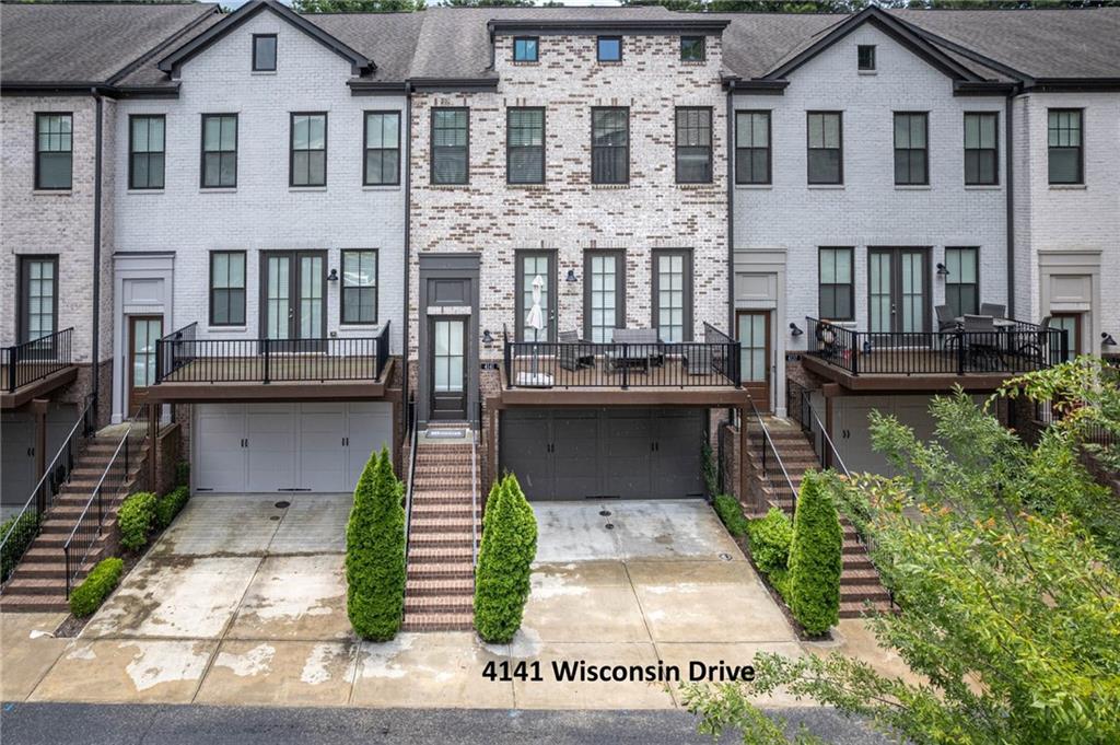 Welcome to 4141 Wisconsin Drive—an exceptional 3BR/3.5BA townhome in the gated Georgetown Square community. Built in 2018, this 2,471 heated sqft Cambridge plan spans three beautifully finished levels. The open-concept main level features engineered wood flooring, 10’ ceilings, and a gourmet kitchen with Bosch stainless steel appliances, quartz counters, designer tile backsplash, white cabinetry, a spacious island, and pantry. Enjoy both a rear grilling deck and a front-facing balcony with tranquil courtyard views. The living area centers around a stacked-stone gas fireplace with custom wood mantel—ideal for entertaining or relaxing evenings. Upstairs, the luxurious primary suite offers a soaking tub, frameless glass shower, dual vanities, and large walk-in closet. A spacious secondary bedroom with its own full bath and walk-in closet completes the upper level. The terrace-level bedroom with full bath is perfect for guests or a home office. Includes a true two-car garage. The convenience of 4141 Wisconsin Drive is unmatched—walk to top-rated Dunwoody schools, scenic parks, and public transit. Minutes from Perimeter Mall, I-285, GA-400, and I-85, this prime location is the cherry on top of an already stunning home.