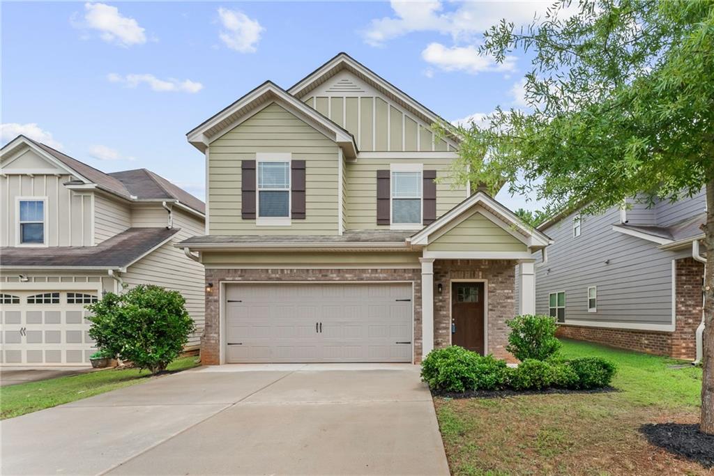 Welcome home to this beautifully refreshed 4 bedroom, 2.5 bathroom residence in the Collinswood at Locust Grove Station community! Built in 2018 and recently updated with fresh paint and brand new flooring—including LVP throughout the main level and plush carpet upstairs—this home blends modern comfort with timeless charm. Step inside to find a bright, separate dining room that flows into the stylish kitchen featuring stone countertops, stainless steel appliances, a breakfast bar, and views of the cozy fireside family room—perfect for entertaining or everyday living. Upstairs, the spacious primary suite offers tray ceilings, a large walk-in closet, and an ensuite bathroom with double vanities and a shower/tub combo. Three additional generously sized bedrooms share a full hall bathroom, and the laundry closet is conveniently located on the upper level. Enjoy outdoor living on the rear patio and the convenience of an attached 2-car garage. Ideally situated with easy access to I-75, Tanger Outlets, and a variety of shopping and dining options—this home is move-in ready and waiting for you!